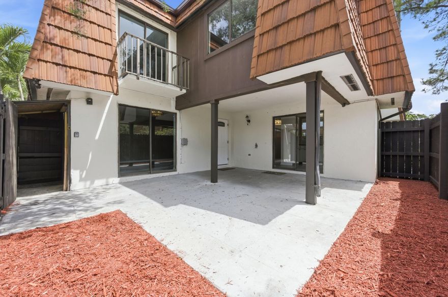 Welcome to this beautifully updated 3-bedroom, 2.5-bath townhouse offering style, space, and comfort. The home features a fully renovated modern kitchen with stainless steel appliances, sleek finishes, and stylish light fixtures. And a new roof (2020), AC (2021), and a new wooden fence (2024). Vinyl wood flooring flows throughout, complemented by light neutral tones and an abundance of natural light from large sliding glass doors that create a bright, airy feel and great flow.  The spacious layout includes a large living room, dedicated dining area, and a convenient downstairs laundry room. Upstairs, both bedrooms are generously sized and designed as dual primary suites, each with its own updated en-suite bathroom. The main suite features a walk-in shower, double sinks, and a private balcony overlooking the courtyard, while the second suite includes a tub and equally refined finishes,  plus ceiling fans in the bedrooms.  Enjoy outdoor living in your private courtyard with space to garden or relax, along with a partially covered patio and additional outdoor storage.   Ideally located near Okeeheelee Park, with easy access to the Florida Turnpike, a short drive to the airport and beaches, and close to shopping, dining, and everyday conveniences including Walmart and El Bodegon. Enjoy 3 parking spaces with plenty of guest parking available.