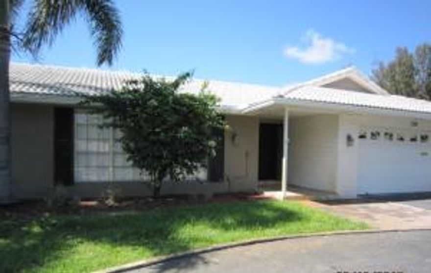 Located in the community of Atlantis.  This is a gorgeous 1 story ranch home with 3 bedrooms, 2 full bath with in-ground fenced in pool and patio.  You can have it all here!!  Large open floor plan with living room which has decorative crown molding, family room with wet bar and it's own sink and granite countertops, a place for a wine refrigerator and dining room.    Double sliding glass doors leads out to open patio and fenced in pool area that backs up to a golf course.  Beautifully landscaped grounds with lots of Palm trees.  Giving you your very own oasis for all the enjoyment of the outdoors.  Great for entertaining guest and family all year long.  Master bedroom and 1 guest bedroom has laminate flooring and the other guest bedroom is carpeted.  Master bath suite walk-in shower