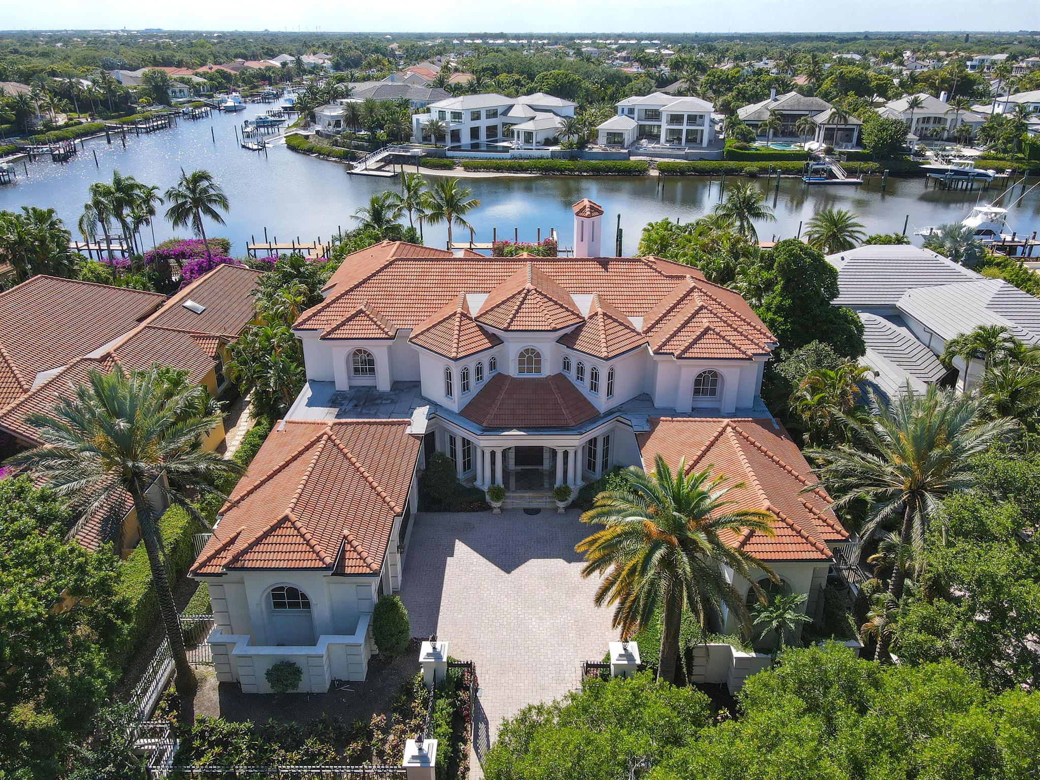 Outstanding custom estate located in the exclusive guard gated community of Admirals Cove. Sits on 110' of water frontage with no fixed bridges. This timeless masterpiece features 5 BR/5.1BA + office, 9,101 Sg Ft soaring ceilings and spectacular water views from almost every room. Luxurious master suite with large sitting room, his & hers baths and walk-in closets. Gourmet kitchen. Step outside to be greeted by a resort styled back yard with large pool & spa, lush landscaping. Brand new summer kitchen makes it perfect for entertaining and enjoying the beautiful sunsets and tranquil water views.FURNITURE INCLUDED. Amenities: 45 holes of golf, 5 restaurants, 58 slip marina with floating docks, Yacht Club, Har Tru tennis courts, pickelball courts, and state of the art gym.
