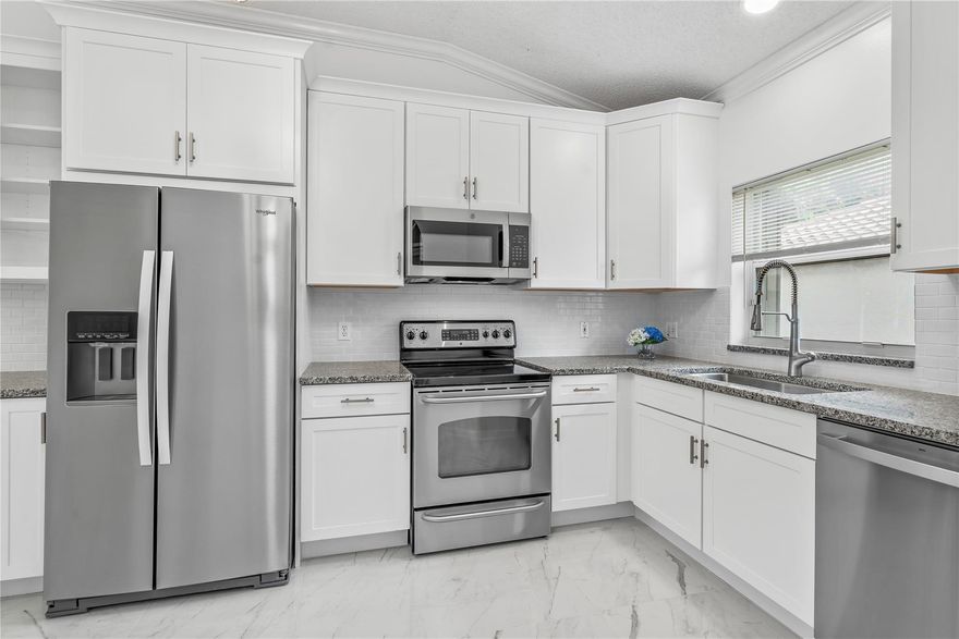 Welcome home to this completely renovated 3 bed/2.5 bath corner villa ready to move in and enjoy Florida living! Brand new kitchen features white shaker cabinets, subway tile backsplash, granite countertops, new appliances & tons of storage!  Primary bathroom completely redone and updated 2nd and 3rd bathrooms. 10’ ceilings in the living/family room area enhance the natural light and lead to the screened in patio with a garden view. 24x24 tile throughout the living areas, new lighting and much more! Roof 2016, AC 2019, hot water heater 2020, full size washer/dryer and accordion shutters.  Two pets welcome up to 35lbs. Isles of Aberdeen is an active adult 55+ community which offers card room, swimming pools, tennis & fitness.  Golf membership available, but NOT mandatory.