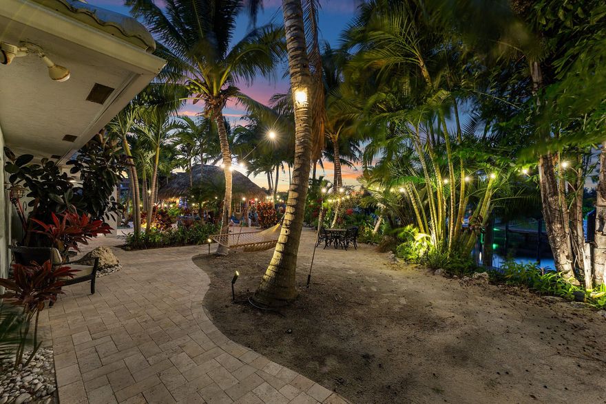 An exceptional 4-bedroom, 4-bath residence set on an impressive 242 feet of waterfront frontage, positioned on a premier point lot—one of the largest currently available in Lighthouse Point. This stunning home showcases a spacious open-concept layout with soaring volume ceilings, a grand chef's kitchen, and seamless indoor-outdoor living. The resort-style exterior features a grotto-inspired pool, ocean-view spa, lush tropical landscaping, and a private, oasis-like atmosphere ideal for entertaining. Perfectly located with direct ocean access and breathtaking panoramic water views from every angle.