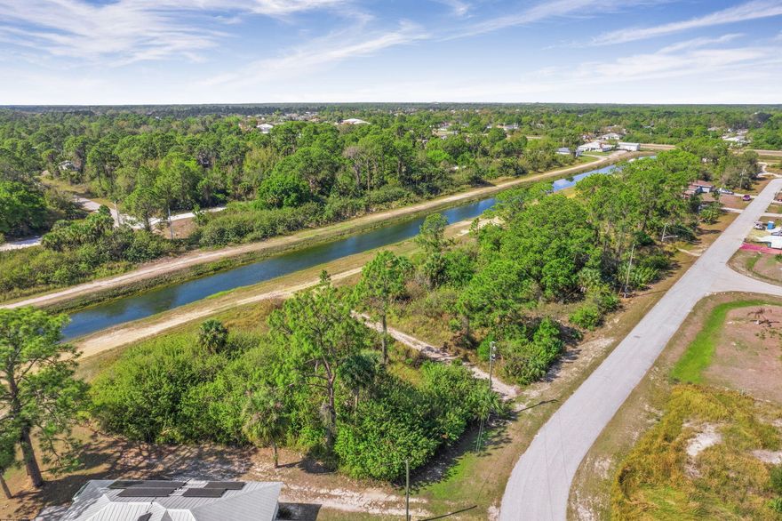 Rare oversized 0.35-acre canal-front lot in a rapidly growing area of Lehigh Acres. This is not your typical lot — the added space and canal frontage provide privacy and a premium feel that stands out from surrounding properties. Ideal for builders or investors seeking a strong opportunity in an area with ongoing new construction. No HOA restrictions. Well and septic required. Don't miss this chance to secure a standout lot with long-term upside. Ideal for custom home or investment in a Growing area with new construction nearby