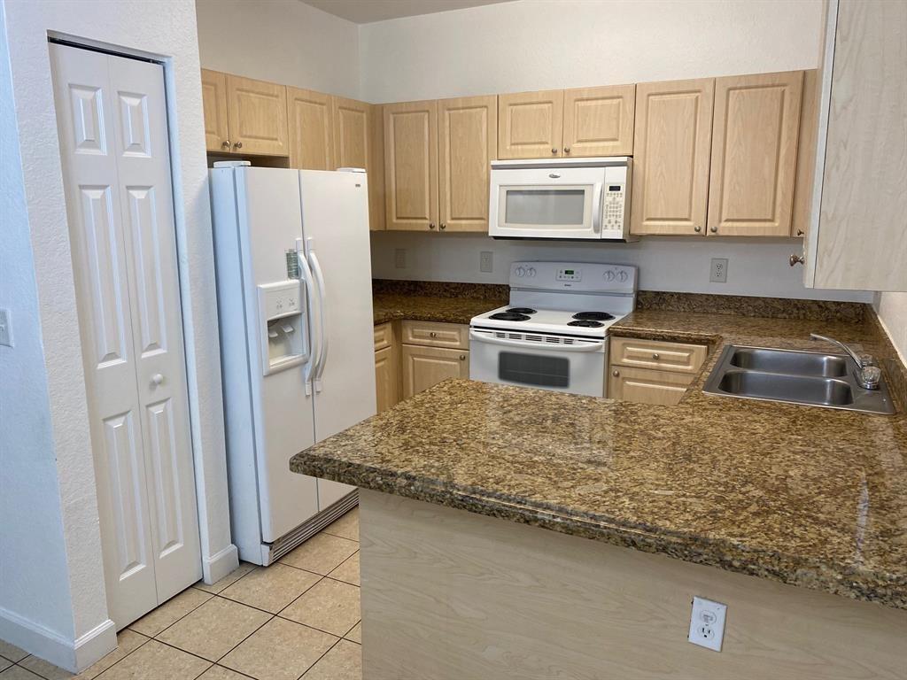Amazing 3 bedroom 2 bath now available in gated community of Caribbean Isles! This unit boasts one of the largest private fenced in patio in the community!! 1st floor corner unit. Granite in kitchen. Gorgeous clubhouse with wonderful amenities! Will go fast