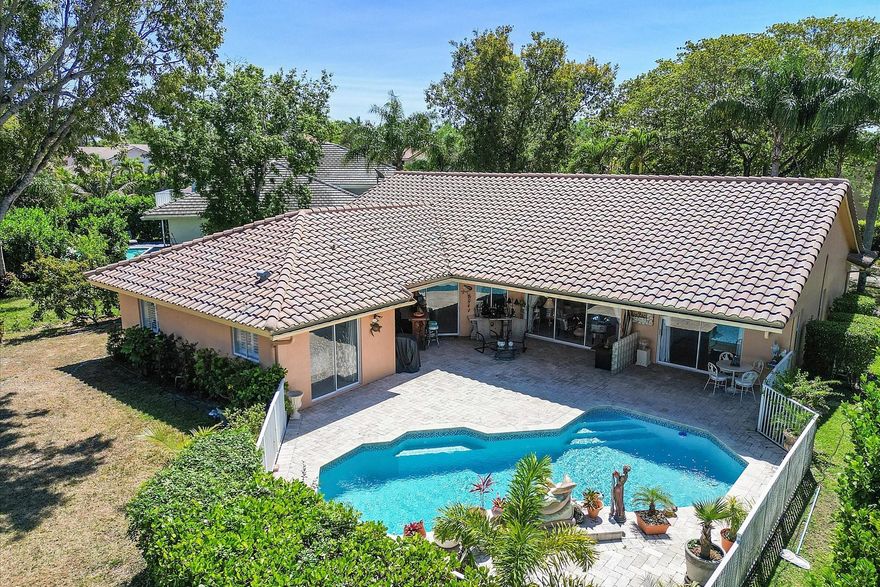 Your Dream Home Awaits! Located in the prestigious, guard-gated Hidden Hammock Estates, this stunning 4-bed, 2-bath, 2-car garage home offers a spacious split-bedroom floor plan with soaring vaulted ceilings, abundant natural light, and serene pool & canal views from every room. The kitchen boasts stainless steel appliances, kitchen island (counter recently tiled-onyx), and an open-concept layout. The private primary suite features dual walk-in closets, sliding doors to patio/pool. Primary bath offers whirlpool tub and separate shower. Step outside to a covered lanai, waterfall pool, lush fruit trees (avocado & mini banana), and tranquil water views. Recent upgrades include newer water heater, electrical panel, A/C (2021), and pool resurfaced and retiled (2021). Call for a private tour!