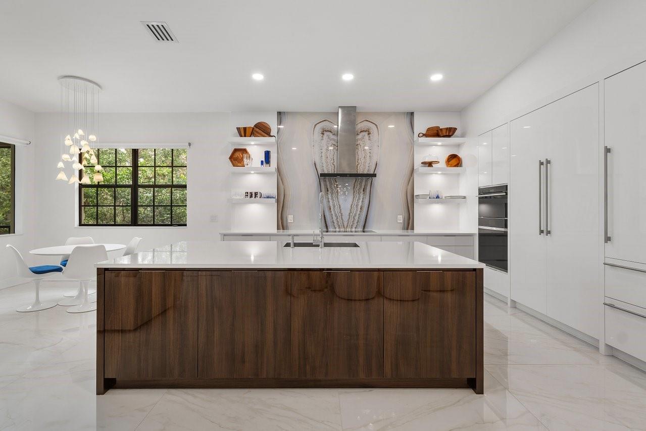 Live the ultimate country club lifestyle in this exquisitely renovated Caseras coach home in the prestigious Parkland Golf & Country Club. This customized 4BR/2BA upstairs residence with private elevator boasts a sleek open layout and an extraordinary modern kitchen featuring premium Wolf/Sub-Zero appliances, an ASKO dishwasher, customized cabinetry, a TopZero sink, and white 48X48 Italian porcelain flooring throughout (including the lanai). The show-stopping kitchen is anchored by an oversized island topped with spectacular quartz countertops—perfect for both entertaining and everyday living. The luxurious primary bath offers a spa-like steam shower with body jets and rain head. Striking glass stair railing adds modern elegance to this space. Monthly HOA and Sports Club Fees $2,161/mo.