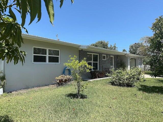 M:r clean live here. CBS home on a corner private lot with driveway on side street. Tile flooring throughout. Florida room leads to privacy fenced yard. Garage features front and rear doors. Impact windows, metal roof, a lots of fruit tress, well water sprinklers, workshop, bring your toys, utility room ,water softener and more ,do not miss this opportunity