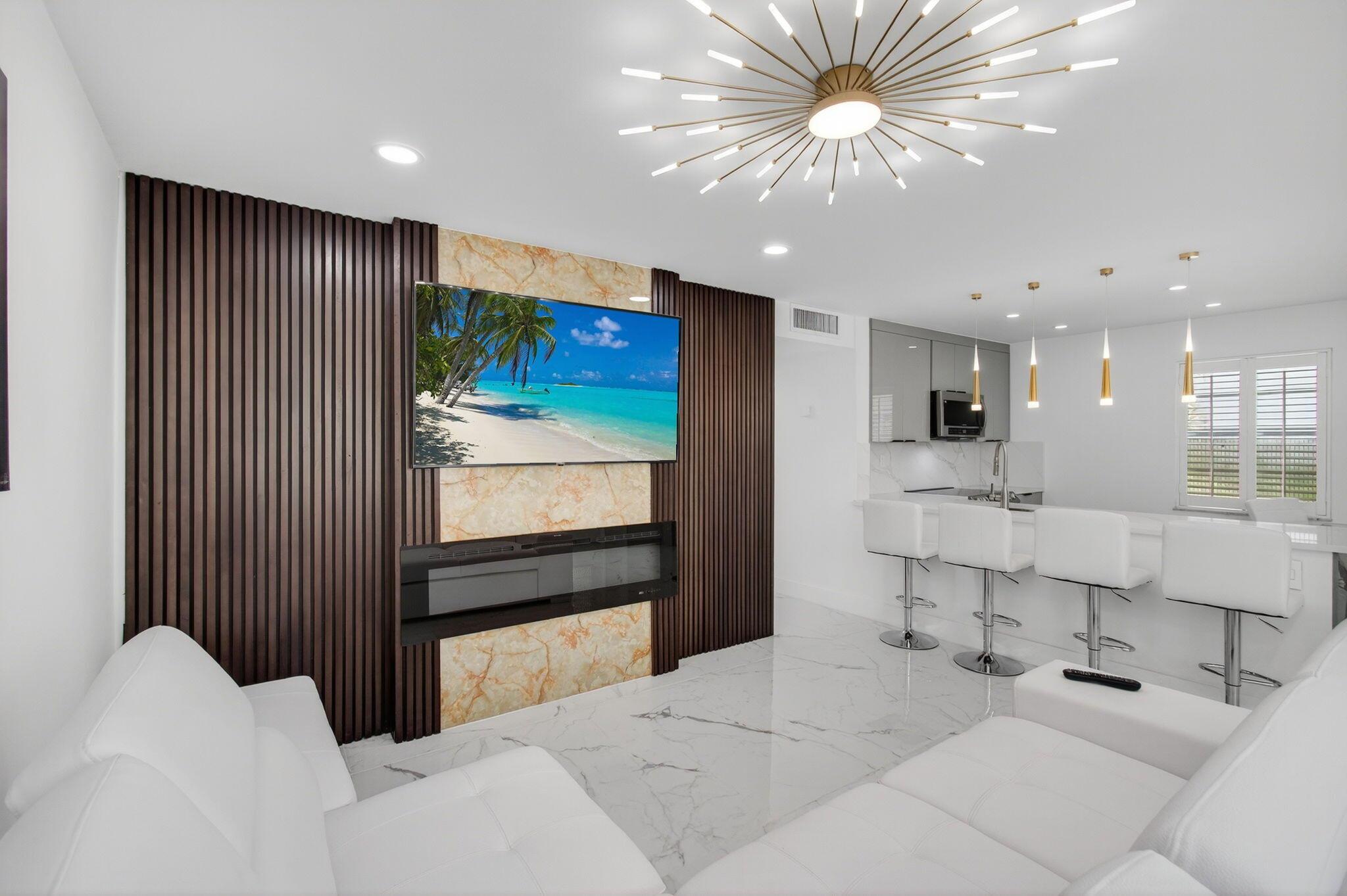 Prepare to be impressed--this 1st-floor 2 bed, 2 bath Kings Point condo showcases one of the most stunning top-to-bottom designer renovations in the community, offering pure modern luxury. The open-concept layout features tile floors throughout, a gourmet kitchen with quartz counters, large counter peninsula, stainless steel appliances, and elegant lighting. The living room boasts a custom accent wall with fireplace and mounted TV, while spa-inspired baths and spacious bedrooms create comfort and style. A new washer & dryer add everyday convenience, and the enclosed patio with tranquil garden view is the perfect spot to relax. Kings Point offers resort-style living with golf, pools, tennis, pickleball, fitness, clubhouse, theater, dining, and more--just minutes from downtown Delray Beach.