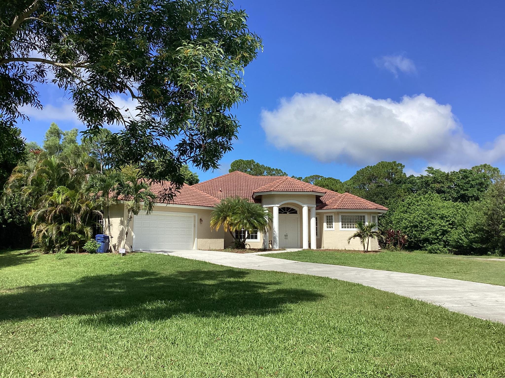 CBS 3 bedroom 2 bath 2.5 car garage in Jupiter Farms. Large rooms, granite counter tops, open floor plan, Large screened in back patio. 12ft ceilings. Barrel Tile roof. Located on paved road, 1.09 acres close to Indiantown Rd.