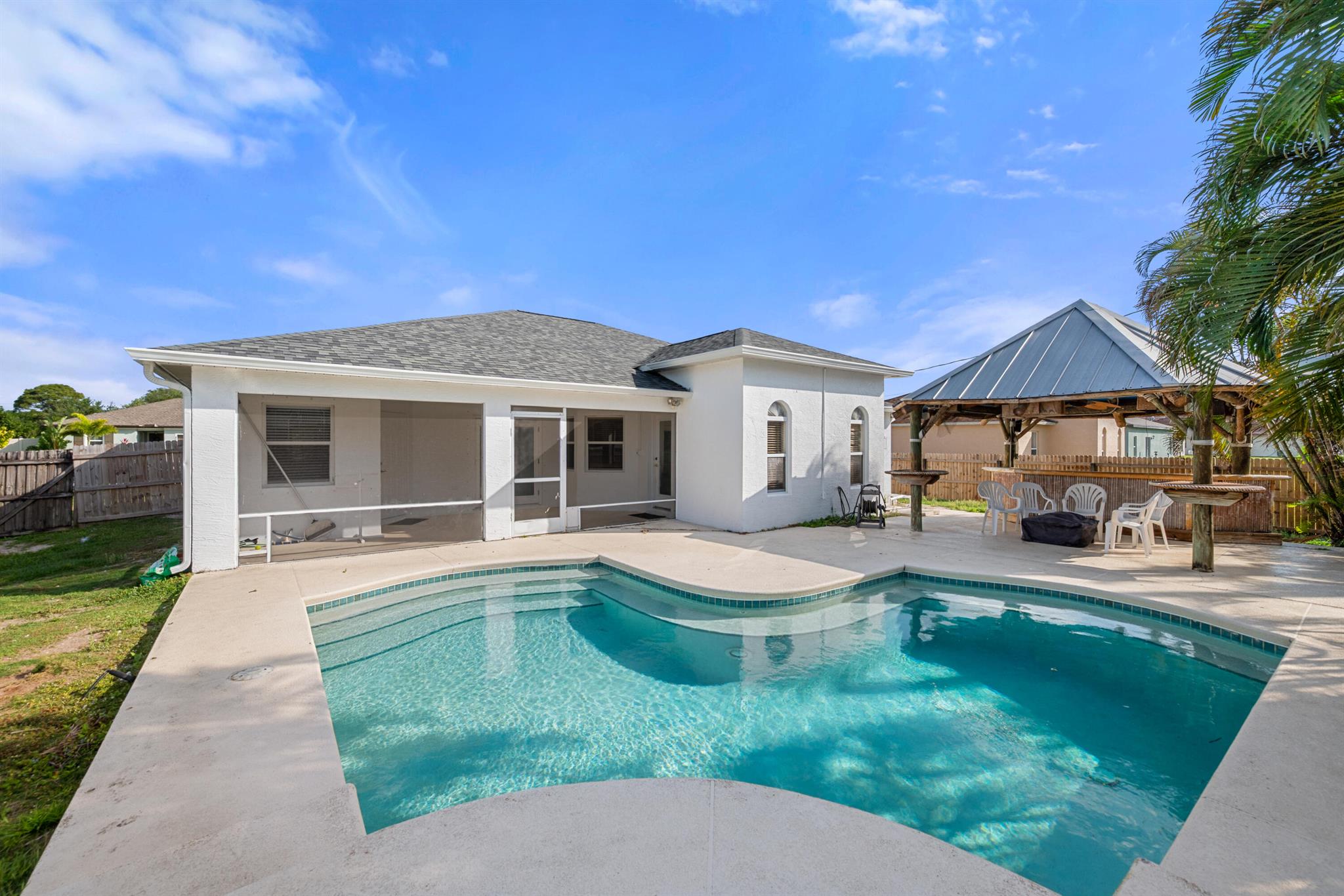 Amazing Opportunity! Discover this Solid Concrete Built Custom Pool Home! Important features include a NEW Roof in 2022, a NEW Water Heater in 2022 *PLUS* every window & door is Hurricane protected.The Over-Sized Garage(441sqft) & Driveway are Perfect for Truck/s, Motorcycle/s, Boat/Trailer-ALL WITH NO HOA! Step outside to the sparkling pool area & relax or entertain family & friends in the screened-in lanai & let your pets run freely in the fenced yard.The Owner's Retreat offers a shower,a large soaking tub plus a walk-in-closet.The spacious floorplan features a living room,a breakfast nook and a cozy family room.Close to shopping at Darwin Square plus Whispering Pines Park( An active sports park with children's play areas & dog parks). Quick & convenient access to I-95 & ST. Lucie West.