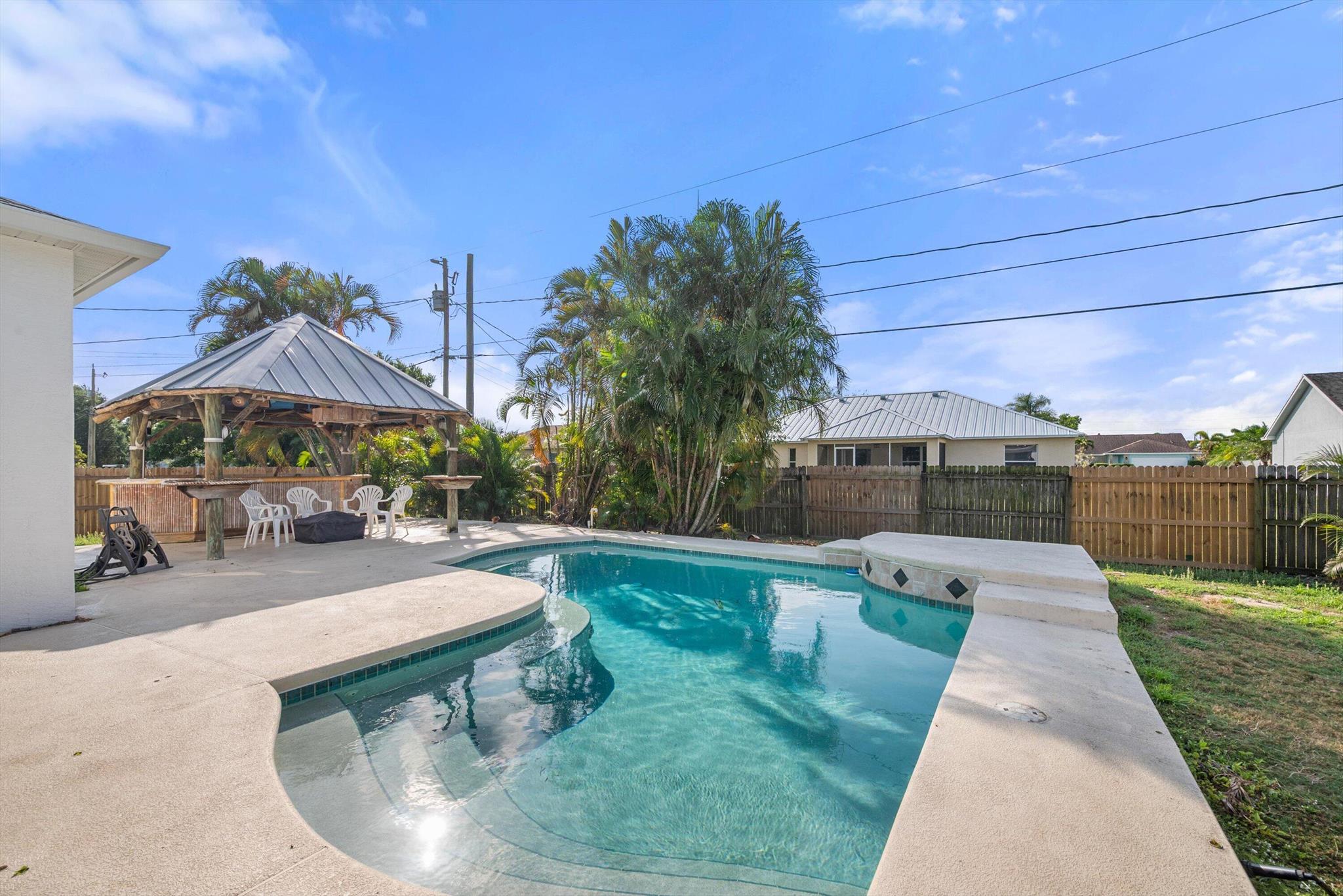 Remarkable Opportunity! OWNER to offer *$6,000.00* towards Buyer's Closing Costs *PLUS* a $600.00 Home Warranty!! Discover this Solid Concrete Built Custom Pool Home! Important features include a NEW Roof in 2022, a NEW Water Heater in 2022 *PLUS* every window & door is Hurricane protected. The Over-Sized Garage(441sqft) & Driveway are Perfect for Truck/s, Motorcycle/s, Boat/Trailer-ALL WITH NO HOA! Step outside to the sparkling pool area & relax or entertain family & friends in the screened-in lanai & let your pets run freely in the fenced yard. The Owner's Retreat offers a shower, a large soaking tub plus a walk-in-closet. The spacious floorplan features a living room, a breakfast nook and a cozy family room. Close to Darwin Square plus Whispering Pines Park & EZ to St. Lucie West.