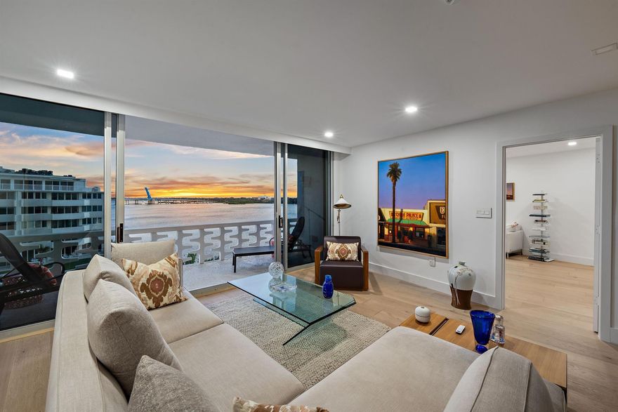 Enjoy breathtaking views and sunsets overlooking the Intracoastal in this meticulously renovated 2-bedroom, 2-bath penthouse, designed for elegance and comfort. The split-plan home is a masterpiece of modern luxury, featuring a custom Italian-design kitchen with high-end appliances, including Fulgor Milano induction range, Miele dishwasher, and Bosch refrigerator, set against stunning Cristallo Royal quartzite countertops and backsplash. Other high-end finishes include, wood flooring throughout bringing warmth and sophistication, custom LED lighting, motorized shades in every room, fine brass hardware in kitchen and baths, and custom closets. The primary bath offers a peaceful retreat with an elegant marble topped vanity and beautiful frameless glass shower. Enjoy peace of mind with