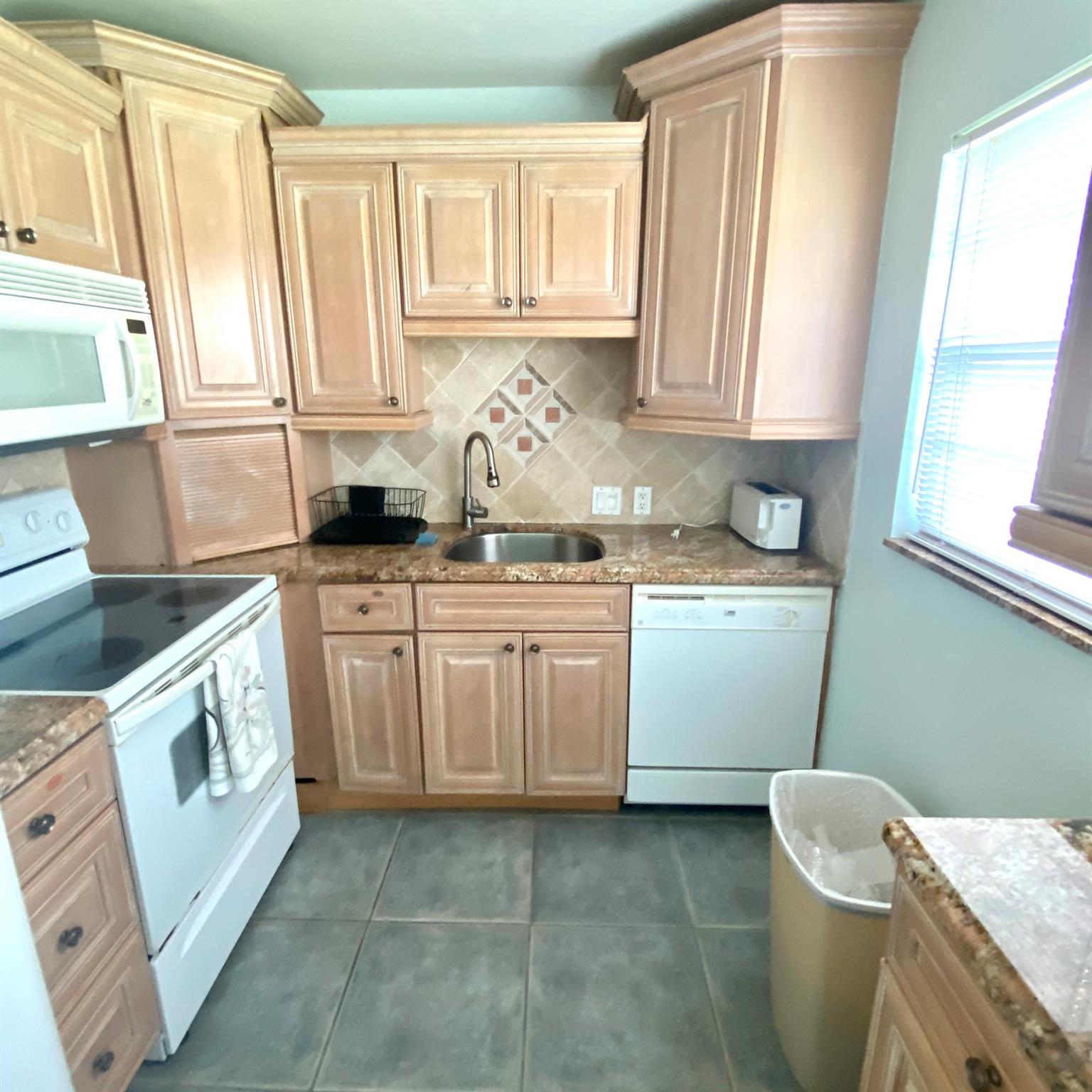 IMMEDIATE LEASING OK. 1ST FlOOR CORNER 2 Bedroom 1.5 Bath. Renovated Kitchen w/ Granite Counter Tops and Lots of Storage.. Furnished Turnkey. Bright and Well Maintained. Lovely Garden View from Screened in Patio. Steps to Community Pool. Walking Wistance Houses of Worship and Clubhouse. Enjoy the Club Amenities, Broadway Caliber Shows, Free Bus Service, Fitness Center, Tennis, Pickleball, Billiards, Social Activities and much more. Complex is a Gated Community with 24-hour Security. Come get some Warmth and Engage in Active Lifestyle in Paradise. Close to Shopping, Restaurants, Art, Culture, Downtown Boca Raton and Historic Delray Beach. 55+Community.