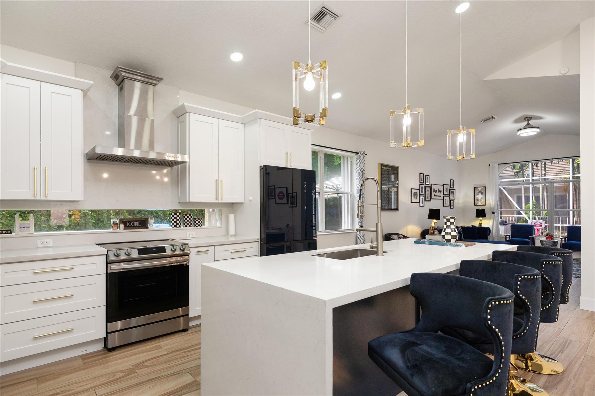 Beautifully updated home on an oversized 14,000 sq. ft. corner cul-de-sac lot in the prestigious guard-gated community of Eagle Trace! This spacious residence features a '22 roof, wood-look porcelain tile & volume ceilings throughout the living areas, wood floors in all bedrooms, a fully updated 2nd bathroom, '24 water heater, '19 A/C, resurfaced pool, closet cabinetry, accordion hurricane shutters & a recently painted exterior. The remodeled kitchen is a showstopper w/ a 9' quartz island, Samsung appliances, white shaker cabinetry & stylish hardware. A wall was removed to create an open-concept layout ideal for modern living. Enjoy outdoor living in the screened-in salt chlorinated pool & patio area. Community amenities include tennis, gym, playground & golf course—no membership req'd!