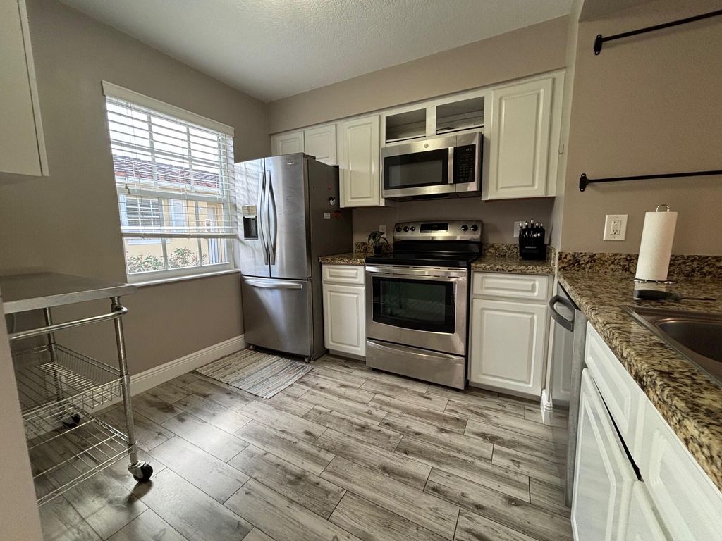 Photo of 1035 Lake Shore Drive #202, Lake Park, FL 33403 (MLS # R11159157)