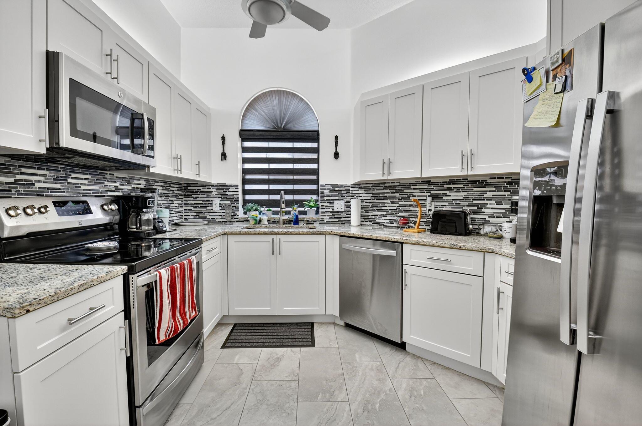 This beautifully maintained home is perfectly situated in Platina's Diamante Village--just steps from a sparkling satellite swimming pool and a leisurely stroll to the vibrant clubhouse, cafe, and recreational amenities. Ascend to the upstairs either by your private staircase or your own elevator, a feature that adds charm and accessibility the moment you step inside. Throughout the home, gleaming tile flooring reflects an airy, contemporary atmosphere, setting the stage for relaxed Florida living. The updated eat-in kitchen features crisp white cabinetry, granite countertops, a stylish tile backsplash, and sleek stainless-steel appliances. A large pantry and modern finishes create the perfect blend of function and flair.