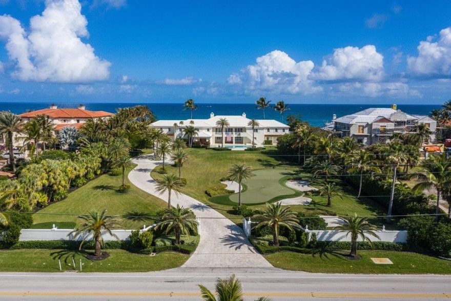 Nestled one mile south of the Eau Hotel in Manalapan, this one-of-a-kind ocean-to-Intracoastal British West Indies estate property is one of the finest estate lots in Manalapan! Encompassing over 2 acres of valuable land, this unrivaled property stretches an impressive 193' of water frontage across each of the beach and lake coastlines and is equipped with a private dock that can support vessels up to 40' and a brand new seawall. As soon as one enters this property, they are greeted by natural light that pours in from the dozens of impact windows and doors that encircle the home. Originally designed by renowned architect, John Volk, the sprawling 12,856 SF home boasts 7 bedrooms and 5 bathrooms and was recently gut renovated for the ultimate in luxury living  providing the perfect canvas for endless customization possibilities. The grand entrance foyer welcomes your guests to a wide-open floor plan that offers unparalleled views of the ocean and intracoastal waterways at every turn of the estate. You and your guests can easily access the formal living room and dining room which features a state-of-the-art wine room for the discerning collector. The renovated dine-in kitchen is just steps away and offers a large center island for serving hors d oeuvres and drinks in the adjacent living room. An oversized balcony overlooks the front of the property, where you can enjoy beautiful sunsets over your private mini-golf course and one of two pools on the front lawn. If you're more into sunrises, simply walk around to the other side of the house where you can watch the sunrise over your private beach and backyard pool.