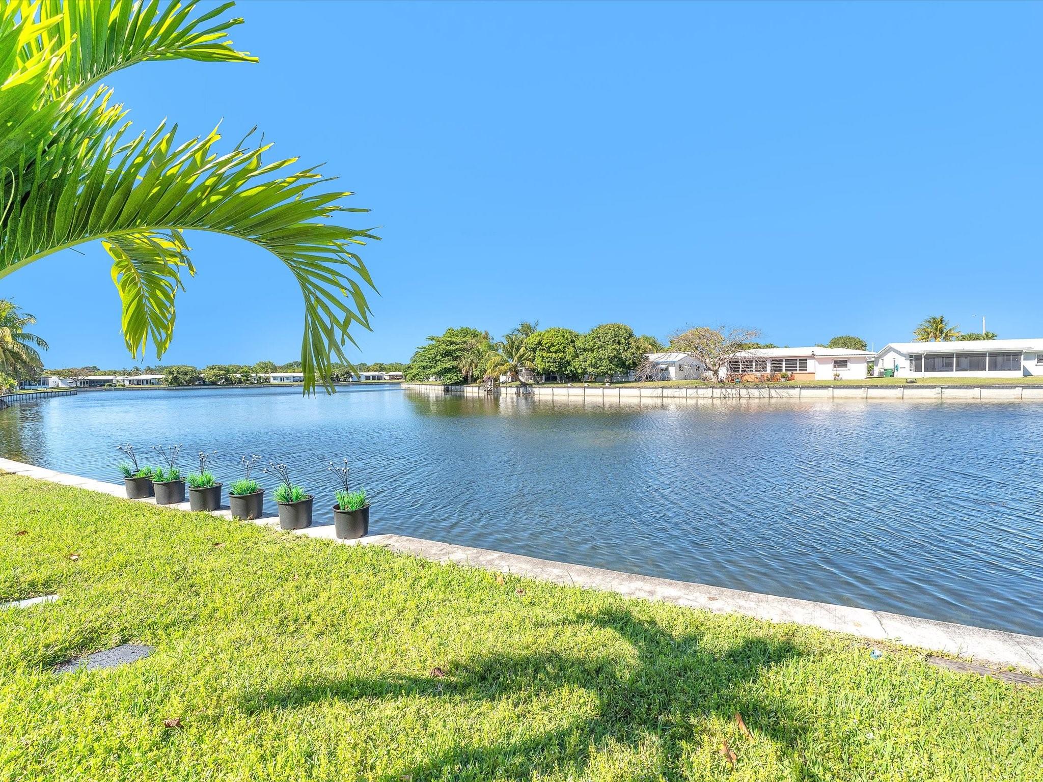 This delightful water view 2-bed,1-bath+Florida room single family home offers the perfect blend of comfort. With new laminate flooring gracing the living, dining, hallway & bedroom. Tiled flooring on bathroom, kitchen, laundry, and inviting Florida room exude elegance. Picture enjoying your morning coffee in the Florida room, with its captivating water views and lush garden brimming with tropical splendor. Professionally landscaped, with New appliances: Washer, dryer, refrigerator, stove, smoke detectors, and garbage disposal. Tile roof 2015,AC 2016. Upgraded 200-amp electrical panels. Located near majors highway ,shopping centers and diff. amenities. Full price offer will receive 5,000 SELLER'S CREDIT toward buyer's closing cost and prepaid beside other closing cost offered.
Call today!