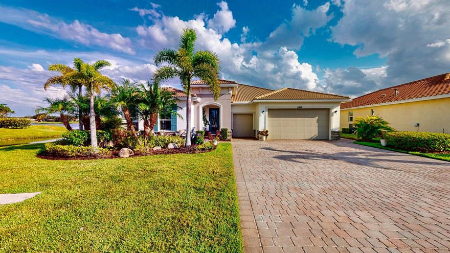 This stunning upgraded 3-bedroom, 2.5-bath home with office is set on a prime quiet cul-de-sac lot, offering over 2,400 sqft of beautifully living space. Throughout the home, you'll find crown molding, tray ceilings, upgraded lighting & fans plus built-in speakers in both the living room and lanai. The GARAGE is a standout with a 4-foot extension, golf cart garage, premium NewAge 24'' deep steel cabinets, shelving, HyLoft storage racks, & a floored attic with a elec pulley for safe access. Recent updates: new AC, dishwasher, & hot water heater, for long term use. Two guest bedrooms share a full bath, while a stylish half bath is perfect for guests. Enjoy open 180A lake views from your 24x54' travertine lanai complete with a 7x20.5' heated fountain saltwater POOL, gas firepit & BBQ.