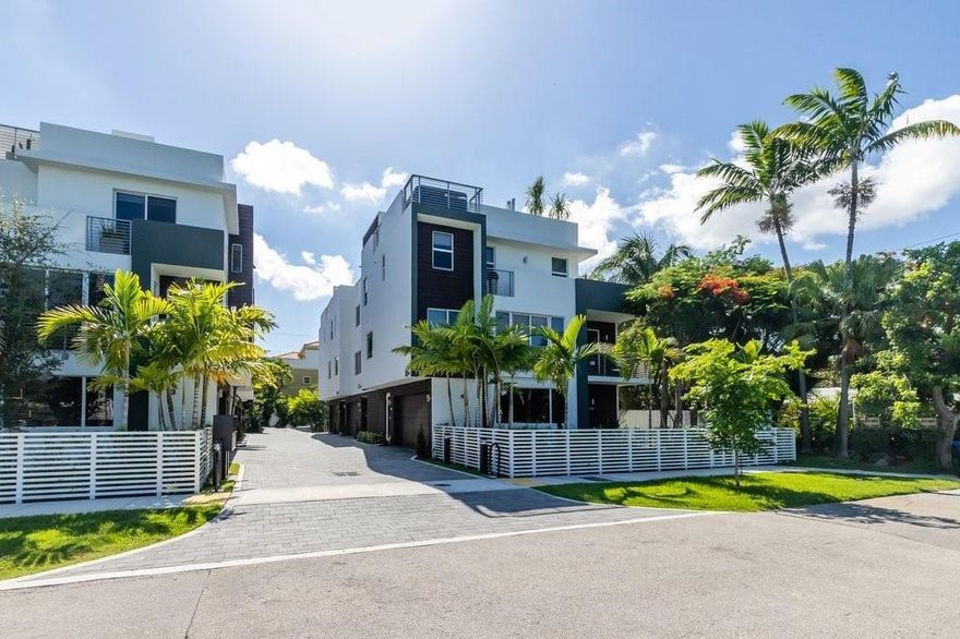 No expense spared on this 2021, modern townhome! 4 bedroom w/ rooftop jacuzzi and solarium, terrace and patios overlooking Holiday Park's spectacular greenery. Private patio on ground floor outfitted with turf for easy upkeep. Home is wired for smart-home systems and features a private elevator, LED lighting, floor-to-ceiling energy-efficient tinted impact windows, laundry room, marble, tile, and durable laminate flooring, marble and granite kitchen, stainless appliances, private garage, Toto toilet/bidet in master, large capacity washer/dryer & more! Rooftop jacuzzi, firepit and furniture included in sale.
