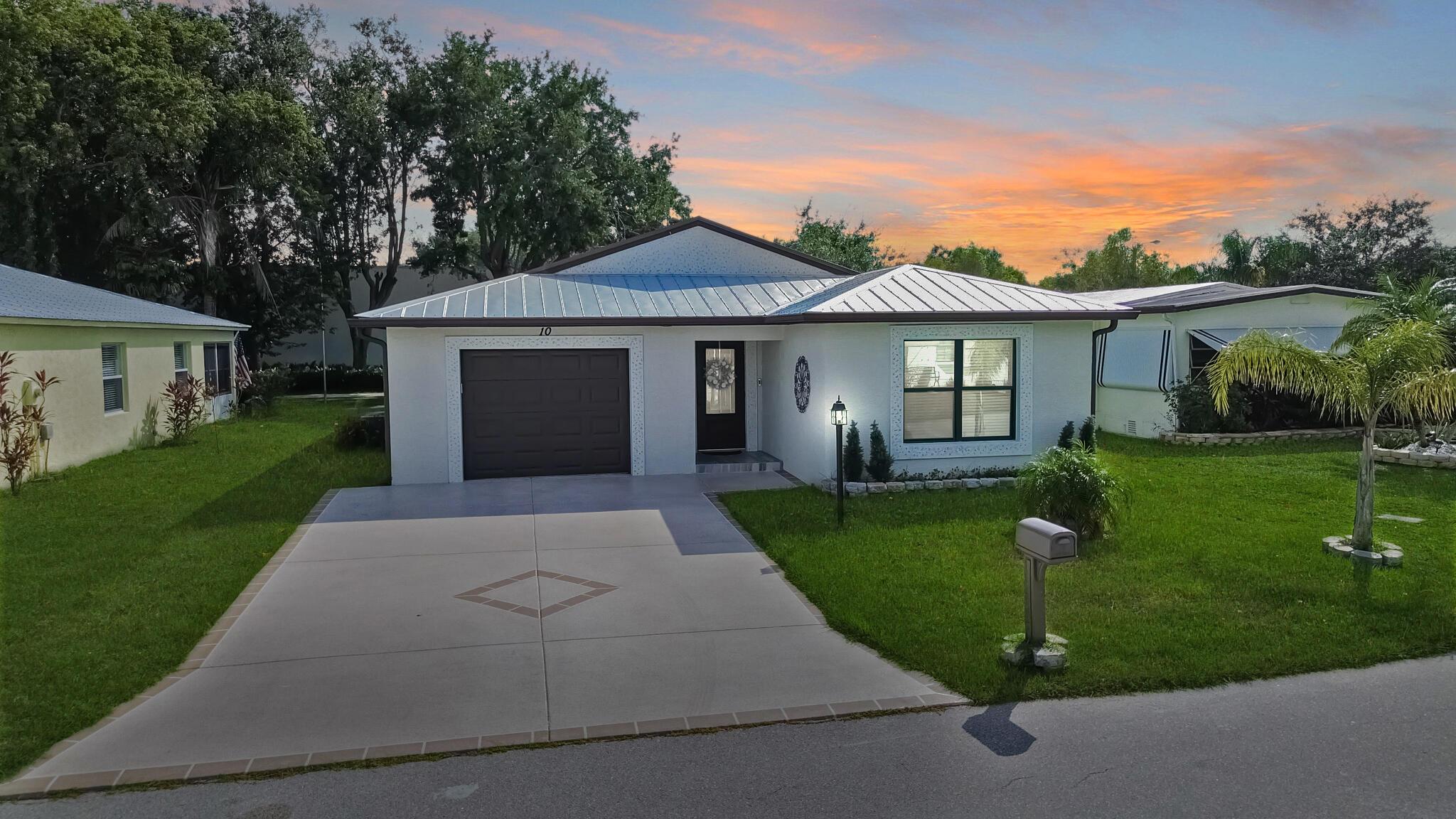 Spanish Lakes Riverfront! Step into modern Florida elegance with this 2023-built 3/2/1 home with flex room, crafted with luxury upgrades and timeless style. A sleek metal roof and high-impact glass combine beauty with peace of mind. Interior features like crown molding, diagonal tile and upscale finishes create a light-filled open plan. The chef's kitchen impresses with quartz counters, 42'' cabinetry with pull outs, and high end stainless appliances. Relax in the one of two spa-like owner's suite or entertain on the oversized screened lanai. Walk to Resort-style amenities in this vibrant 55+ active community including pool, fitness center, pickleball. Home is on leased land--monthly lease fee applies. Nearly new, fully upgraded, and ready for your Florida lifestyle! A must see!