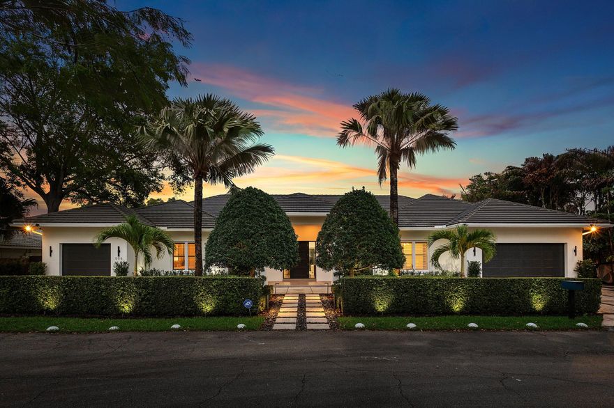 Experience refined single-story living in one of East Boca Raton's most coveted and rarely available enclaves, adjacent to Old Floresta. Built in 2016, this exceptional ranch-style estate masterfully blends architectural sophistication with effortless livability—offering a seamless floorplan ideal for families and those who value both comfort and elegance. Spanning a thoughtfully designed layout, the residence features five spacious en-suite bedrooms and a refined powder bath, creating the perfect balance of privacy and functionality. The single-level design enhances everyday living, providing ease, flow, and a true sense of home.  At the heart of the residence, a beautifully appointed chef's kitchen showcases a new dual-fuel gas cooktop, premium appliances, and an open-concept design that flows seamlessly into the grand great room—complete with an electric fireplace and built-in bar with wine chiller—ideal for both intimate gatherings and elevated entertaining. Designed with today's lifestyle in mind, the home also includes a dedicated office or den, while a privately situated fifth bedroom with its own entrance and garage is perfect for guests, in-laws, or live-in staff. Outdoors, a resort-style setting awaits with a heated pool, covered patio, and a thoughtfully designed entertaining station featuring a sink, undercounter refrigerator, and generous serving counter—perfect for effortless indoor-outdoor living and hosting. Additional features include impact glass throughout, natural gas, a full-house generator, an Aqualite reverse osmosis (R/O) water filtration system, spacious laundry room, and comprehensive security system. A split three-car garage completes the offering. Perfectly positioned just minutes from Mizner Park, The Boca Raton, pristine beaches, and within close proximity to the area's top-rated public and private schools, fine dining, and luxury shopping—this is a rare opportunity to own a move-in ready, single-story estate in a highly sought-after East Boca location. LUXURY. LIFESTYLE. LOCATION.