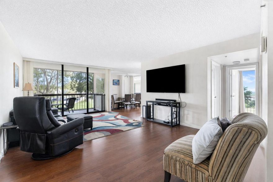 Rarely available corner residence in Boca West, the nation's number one private residential country club, offering incredible natural light and multiple exposures. This unit features floor to ceiling windows in both bedrooms and two screened in balconies—one facing west over the lake with stunning sunset views, and the other overlooking the golf course. The layout and positioning create a bright, open feel that doesn't come up often in this community.    Boca West delivers a true resort experience with over 450,000 square feet of amenities, including four championship golf courses, a 96,000 square foot resort style Aquatics Center, and a 72,000 square foot Lifestyle Center with state of the art fitness, spa, and wellness programming. A major club enhancement is underway, adding a 25 court  pickleball complex, a walkable par 3 short course, and an 18 hole putting course.  Dining options include a high end steakhouse, rooftop bar and lounge, golf side restaurant with drive suites, sushi and wood fire concepts, multiple casual venues, and an on site market.   Mandatory Joining Fee: $150,000; BWMA Capital Contribution: $10,000; Annual Social Dues: $24,454. Club fees are scheduled to increase by $75,000 on October 1st—a strong opportunity to purchase now and lock in current pricing!