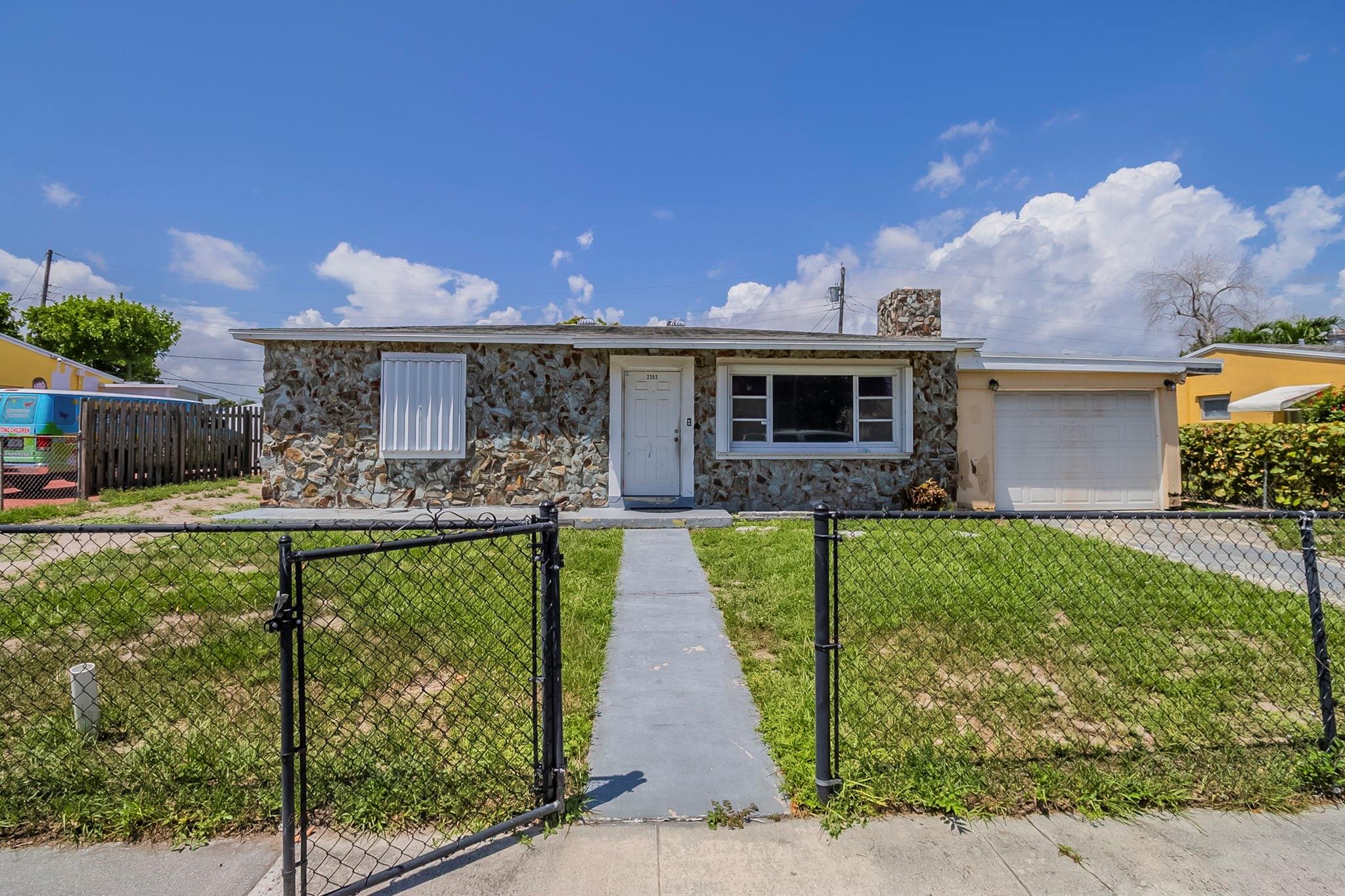 This 1-story home offers 3 bedrooms and 1 bathroom with plenty of potential for the right buyer. Featuring a fireplace in the living room and fenced front and back yards, this property is ideal for those looking for a project. The home is in distressed condition and requires repairs, with appliances and cabinets missing, making it a great opportunity for renovation or investment. Schedule a showing today!