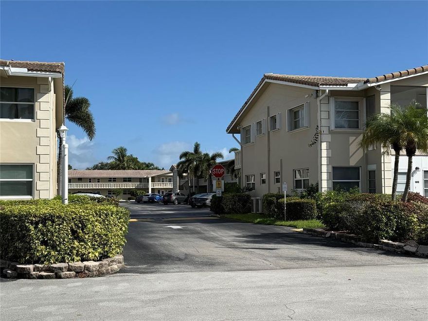 Enjoy affordable 55+ living east of US-1 in this ground-floor condo with tile floors, hurricane protection, and a cozy patio. Ideally situated close to shopping, the senior center, public transit, dining, doctors, hospitals, and local bus service. Located in a charming community surrounded by multi-million-dollar waterfront homes in Lighthouse Point.