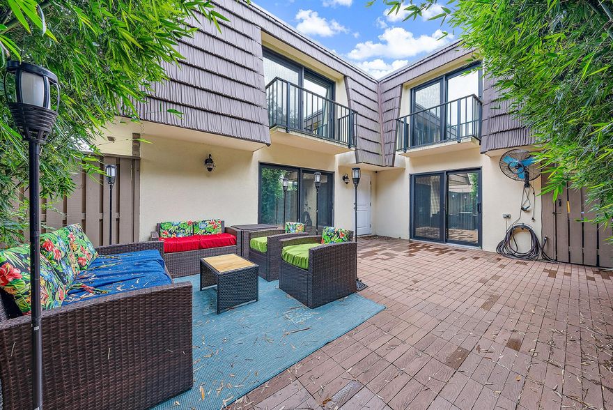 BEAUTIFUL and fully renovated townhome in the heart of Palm Beach Gardens. New roof in 2021, FULL IMPACT WINDOWS and DOORS , new AC, new flooring, and FULLY FURNISHED! This is truly a move in ready home. Awesome entertaining style patio surrounded by lush landscaping and bamboo to keep you shaded on those sunny south Florida days. Plenty of room for a grill and TV to watch the football games during the fall. Walking inside of this amazing unit you will find a spacious and open floor plan that greets you in the big living room with fireplace for those cozy and cool Florida winter nights. The living room opens up to the dining room and kitchen that is spacious enough to host the whole family for the holidays while cooking in the amazing kitchen open to everything. The kitchen features newer appliances as well as a walkout to the patio for those grilling out or cooking at home days. Downstairs you will also find a half bath and a stackable washer/dryer. Walking up the stairs you will a big under stair storage area that can act as a pantry as well. Walking up the stairs you will be immediately greeted by the first of two bedrooms. This is a big guest bedroom that does have a smaller walkout balcony. Across the hallway is a full bathroom for your guests. You will also find the primary bedroom with its ensuite bathroom and private walkout balcony that overlooks the outdoor patio. The master bathroom is on track to get a new shower from Bath Fitters that is set to be installed mid July as of now. Remember this home is FULLY FURNISHED so you can truly bring your bags and clothes and call it home day one. Fully renovated with all the big ticket items completed for lower insurance rates.