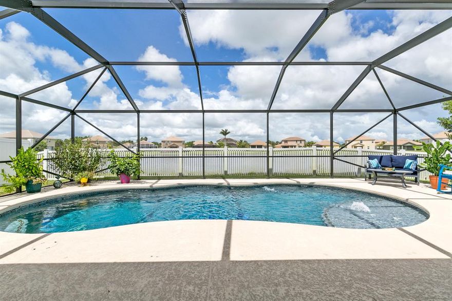 Better act fast on this charming 3/2/2 with pool, screen enclosure, fully fenced, lots of privacy and peaceful, expansive lake views. Home newly built 2015 with full accordion shutters, pool and fence added 2016. Wonderful open floor plan with large kitchen island overlooking the great room and dining area. Kitchen features 42' cabinets, granite, stainless steel appliances and eat in area which overlooks the pool and lake. Master bedroom is enormous!!! Additional length can be used for sitting area or small office area. Two walk in closets have full built in shelving. 2 additional bedrooms are nicely separated from the master for privacy. Gated community across the street from one of Tradition's most beautiful lakes & park. Walk to Traditional shops, restaurants, parks & activities.