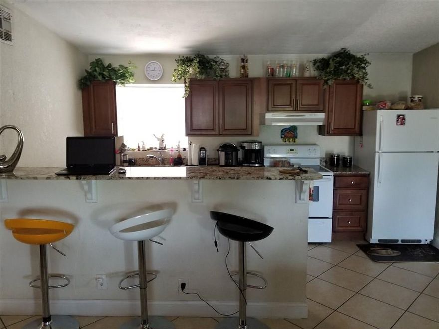 GRANITE COUNTER TOPS, NEWER KITCHEN CABINETS. RENOVATED BATHROONS. 4/2 SINGLE FAMILY. LOTS OF SPACE. FENCE WITH GATE ENTRANCE ON BOTH SIDES FOR A BOAT, TRUCK OR RVs.