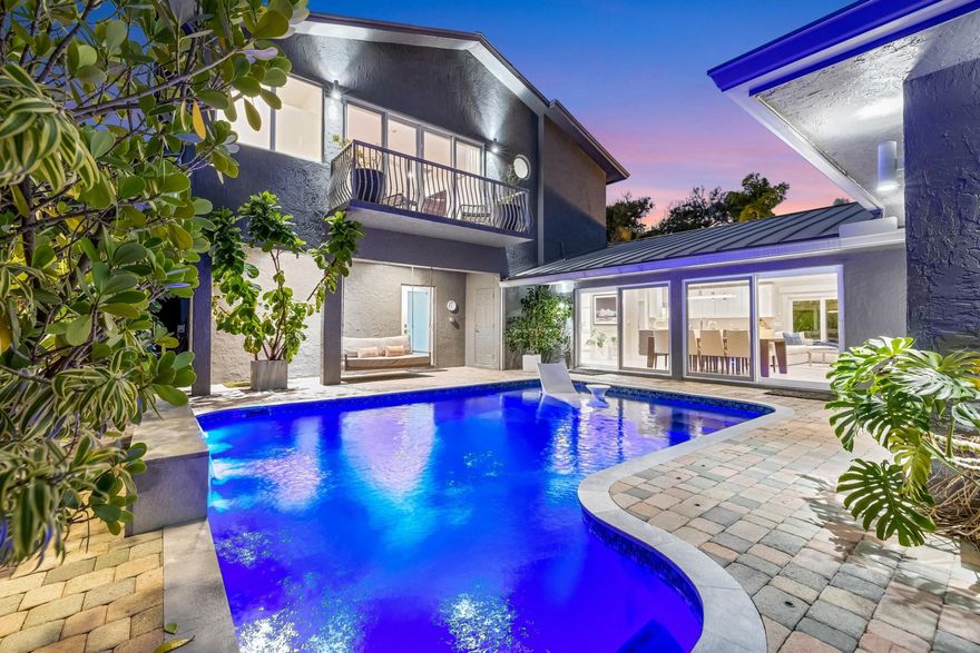 Located in highly desirable gated Harbour Heights, an oceanside enclave with amazing beaches & proximity to SE 17th St shopping & dining, minutes from major highways & airports. It was extensively renovated in 2021 to a high standard. Occupying high elevation! Great flexible & desirable floorplan. Large L-shaped custom kitchen with modern cabinetry & top appliances, home office area, large, open, great room & dining area, custom bar with refrigeration, views over the pool & entertaining courtyard. Of the 5 bedrooms + office, 2 are extremely well-appointed Primary Suites (upper & lower levels), VIP Suite, plus 3 bedrooms (currently office and home gym). All baths are upgraded. Multiple outdoor areas, totally private heated pool, spa, putting green & fully landscaped