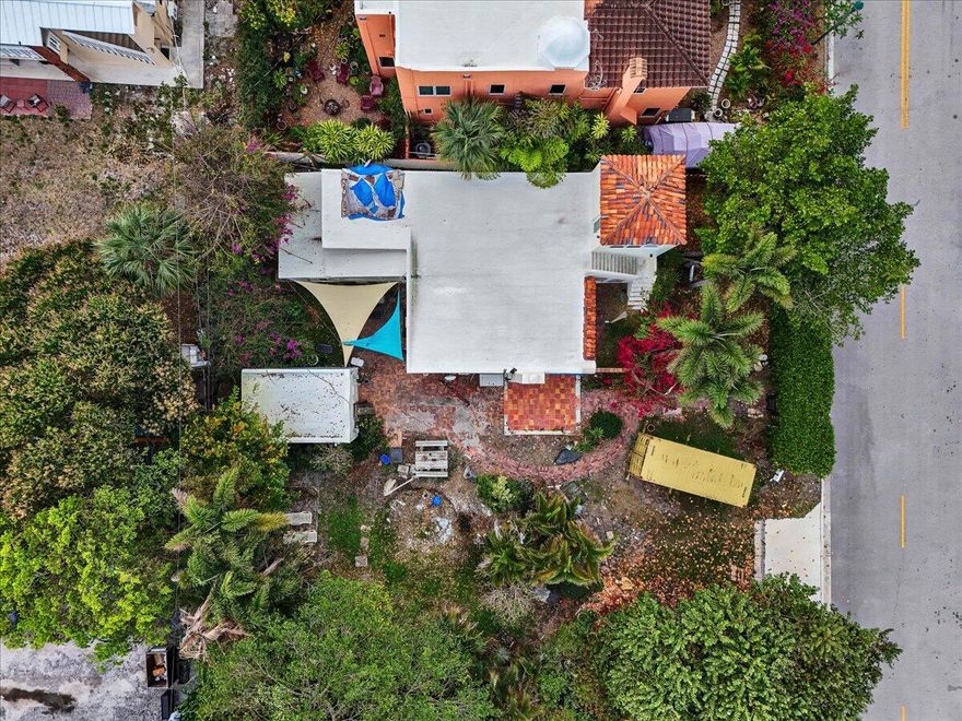 Endless Potential! Opportunity awaits with this historic 1920-built home just two blocks from the Intracoastal, ideally located just south of Southern Blvd. Rich in character, this property features beautiful pecky cypress throughout, offering a rare chance to restore and showcase its original charm.  The home includes 3 bedrooms and 2 bathrooms, with a layout ready to be reimagined. The property has sustained fire damage and will require full renovation, making it perfect for investors, builders, or buyers looking to create a custom coastal retreat.  Situated in a highly desirable area with close proximity to water access, dining, and shopping, the location alone makes this a standout opportunity.  Legal Disclaimer: All persons entering the property do so at their own risk.