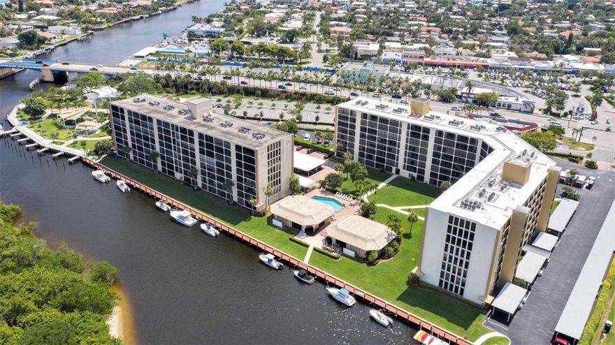 GORGEOUS WATER VIEWS FROM THIS TOP FLOOR 2/2 CONDO OVERLOOKING THE HILLSBORO RIVER, SULLIVAN ISLAND PARK NATURE PRESERVE, THE INTRACOASTAL & EVEN A GLIMPSE OF THE OCEAN. KITCHEN REDONE w/ OPEN FLOOR PLAN, UPDATED BATHS, IN UNIT WASHER/DRYER, WALK IN CLOSETS. LIVING & MASTER HAVE SLIDERS TO THE LARGE SCREENED BALCONY; RELAX W/ A BOOK OR WATCH ALL THE BOATING ACTIVITY. YOU WILL LOVE THE LOCATION JUST WEST OF THE HILLSBORO BRIDGE & ACROSS FROM THE COVE SHOPPING PLAZA W/ ALL IT'S RESTAURANTS & SHOPS. EASY ACCESS TO BEACH & I-95. FRIENDLY ALL AGES COMMUNITY WITH AMMENITIES INCLUDING BOAT SLIPS FOR RENT, POOL, CLUBHOUSE, EXERCISE ROOM W/ SAUNA & SHOWERS, GRILLING/PICNIC AREA., COVERED PARKING. HOA INCLUDES CABLE, WATER, SEWER, TRASH, BUILDING MAINTENANCE.