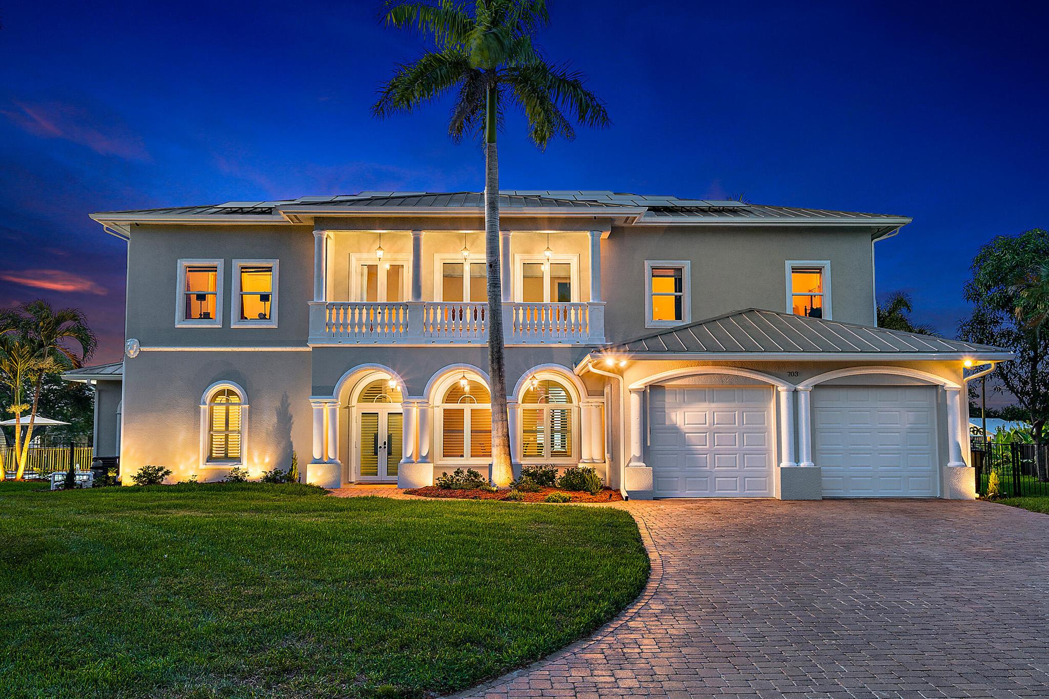 This STUNNING 7-bedroom, 6.5-bathroom custom-built estate offers 5,064 sq. ft. of luxurious waterfront living with ocean access, nestled in the heart of Port St. Lucie. With no HOA restrictions, this two-story masterpiece features panoramic Intracoastal views, impact windows and doors throughout, and a newly replaced dock and lift that accommodates up to a 26-28 ft. boat. This property has also been a highly profitable short-term rental investment.Step inside and be greeted by an expansive open floor plan bathed in natural light. To your right, the gourmet kitchen boasts a walk-in pantry and convenient access to the formal dining room, which has been enclosed with plantation shutters for added privacy. Straight ahead, the spacious living area