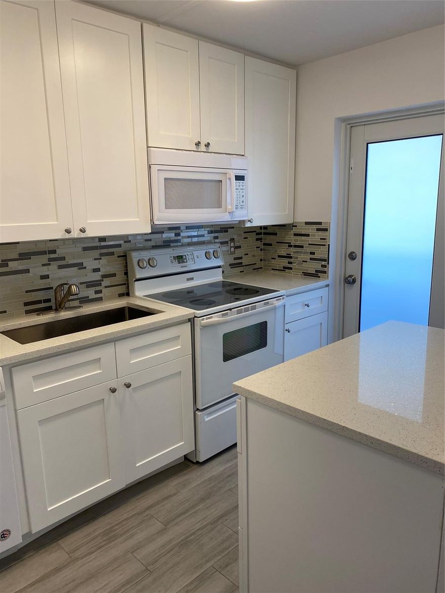 Beautiful upgraded top corner unit, 2 bedrooms, 2 full baths  with impact windows throughout for added security and natural light. This unit also boasts new doors and upgraded quartz countertops. Spacious walk-in closets, indoor and outdoor tile flooring with screen balcony offering a lovely garden view. Assigned parking, assigned indoor storage, laundry facilities, elevator. Community amenities, large swimming pool, gym, pool table, BBQ area, shuffleboard. Boat docking space (25ft) onsite upon availability. All ages community. No pets allowed. Association requires 640 min credit score, 3 to 4 weeks for tenant approval. Landlord requires renter's insurance. Annual lease.