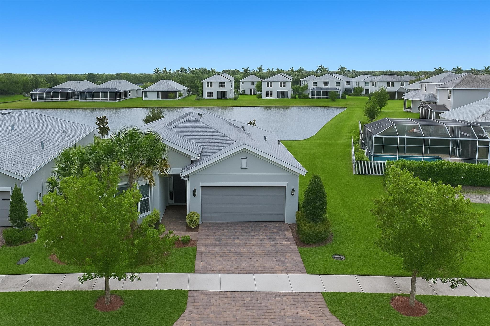 Welcome to this beautifully-designed 3-bedroom, 2-bath home located in one of Tradition's most desirable neighborhoods. Constructed in 2021 with sturdy CBS block construction, this smart home combines energy efficiency with elegant, modern finishes for a lifestyle of comfort and convenience.The thoughtfully designed open, split floor plan offers seamless flow and functional privacy - ideal for both everyday living and entertaining. Throughout the interior, you'll find tasteful plantation shutters, impact-rated windows, and sleek flooring for a streamlined look that's both stylish and low-maintenance.At the heart of the home is a gourmet kitchen featuring quartz countertops, stainless steel appliances, under-cabinet lighting, and an expansive island - perfect for gatherings.