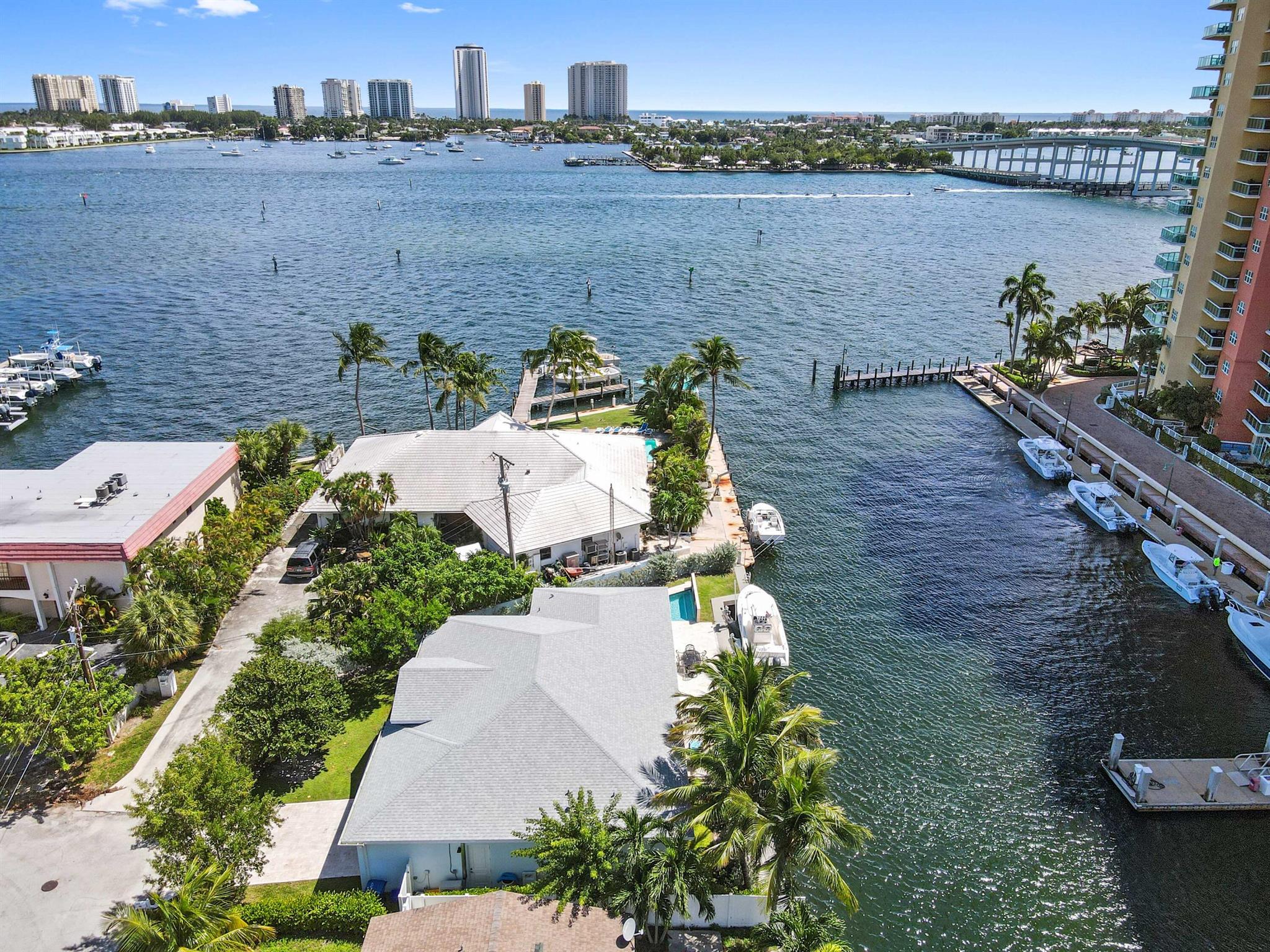 Don't miss the chance to explore this exquisite, one-of-a-kind 2019 custom-built residence boasting an impressive 116 feet of waterfront! Experience a boaters dream with the true essence of waterfront living with unrestricted access to the ocean, as there are no fixed bridges in your path and a 15,000 pound boat lift. Easy access to the marina across from this property allows for quick re-fueling too! Start your day with a cup of coffee on the porch while taking in the beautiful sunrise over the intercoastal.Step inside this home with an open and inviting floor plan, adorned with wood-patterned tile floors, sleek quartz countertops, top-of-the-line stainless steel appliances, 8-foot doors, a generously sized kitchen island, and a luxurious jetted pool enclosed by a privacy wall.