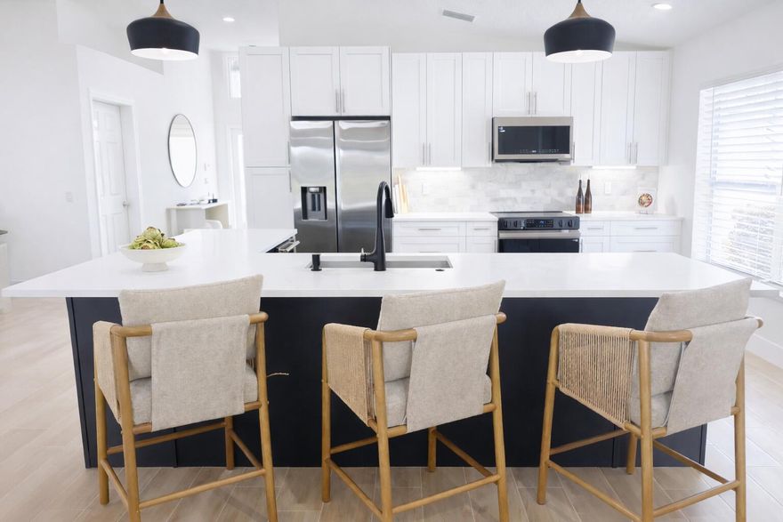 COMPLETELY RENOVATED and move-in ready, this spectacular 3BR/2BA Caspian model home offers beautifully refined living space with breathtaking water views and no detail overlooked. Enjoy total peace of mind w/ FULL IMPACT WINDOWS & DOORS, NEW ROOF, NEW A/C and Hot Water Heater (2024) combining modern efficiency, storm protection and exceptional curb appeal. The chef's kitchen is truly the heart of the home, showcasing brand new stainless steel appliances, wine refrigerator, and premium finishes throughout. It's both functional and striking perfect for everyday living and effortless entertaining. Designer-curated bathrooms elevate the home with spa-like elegance, featuring a freestanding soaking tub and walk-in showers that create a serene retreat. The oversized Florida room is a showstopper, offering panoramic water views and seamless indoor-outdoor living. Ideal for relaxing mornings, sunset evenings, or hosting guests year-round.

Located in the prestigious, gated, and pet-friendly community of Valencia Lakes, residents enjoy a newly renovated clubhouse with café, resort-style pools, spa, tennis, pickleball, and an active lifestyle calendar. Just minutes to beaches, dining, and shopping.

This is true lakefront luxury, completely turnkey and ready to enjoy.