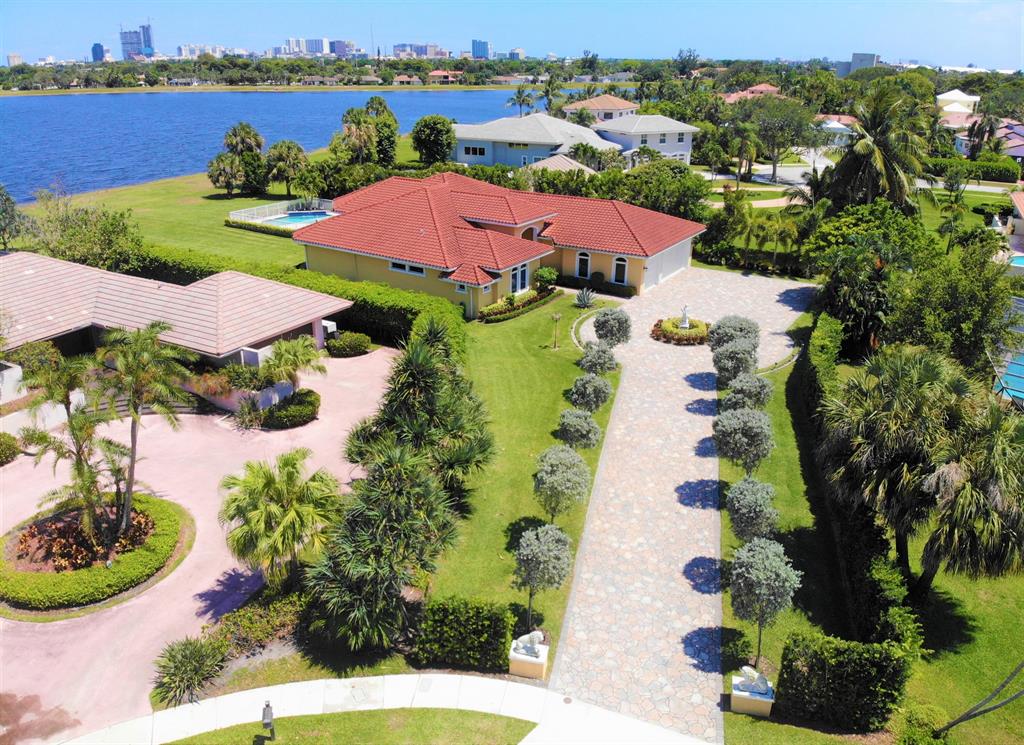Enjoy fabulous Lakes Views and the prevailing eastern breezes from this 2016 4 bedroom 4.5 bath waterfront residence. High ceilings, telescoping impact resistant sliding glass door walls, large kitchen gracious patio area, 4 en-suite bedrooms, an additional cabana bath, 3 car garage, salt water pool with built in bar area, a gated community, located near the beach, the Palm Beach International airport, downtown City Place (Rosemary Square), the Palm Beach outlets, and local golfing. This beautiful home is on a cul-de-sac, and features a long private driveway and a view of rolling greens from the patio all the way to the water's edge;