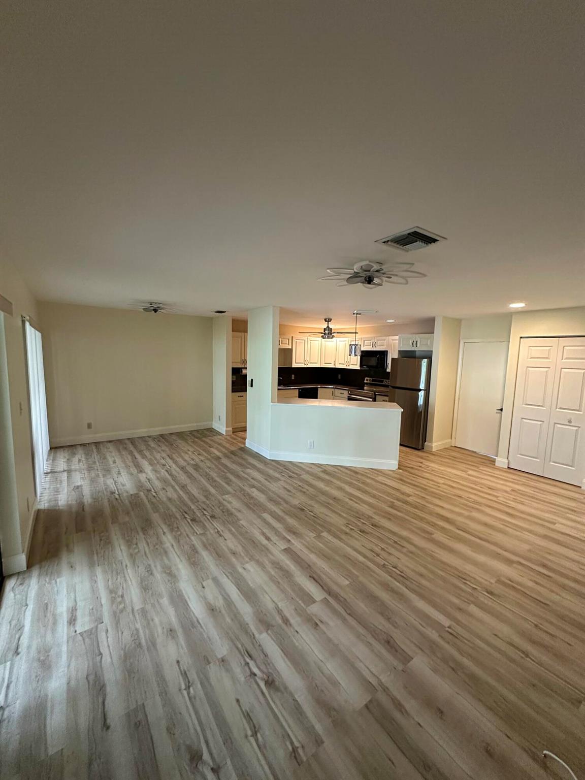 Welcome home to this delightful 2-bedroom, 1-bathroom ground-floor condo, boasting the highly sought-after convenience of an attached garage. Enjoy the privacy and accessibility of single-level living, with no stairs to climb. The attached garage provides secure parking and additional storage. A true gem for those seeking comfort and practicality! Luxury vinyl flooring that looks like wood gives it a tropical charm. Newer stainless steel appliances, washer and dryer in garage, and extra storage room. Located in Lexington Green subdivision of the PGA National community. This is a must see...schedule your showing today.