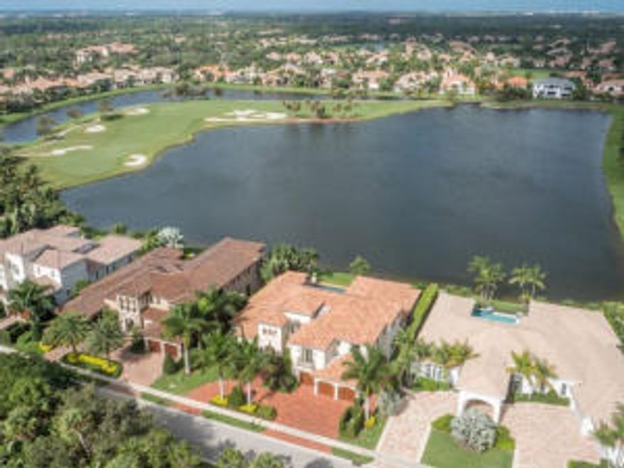 Magnificent custom contemporary estate, built in 2011 with flawless design, located on the most desirable lakefront property nestled in Frenchman's Reserve gated community. As you enter the imported Columbian solid wood cathedral front door of this impeccable home, you are captivated by the stunning water views, floor to ceiling windows in the living room with custom fireplace, and