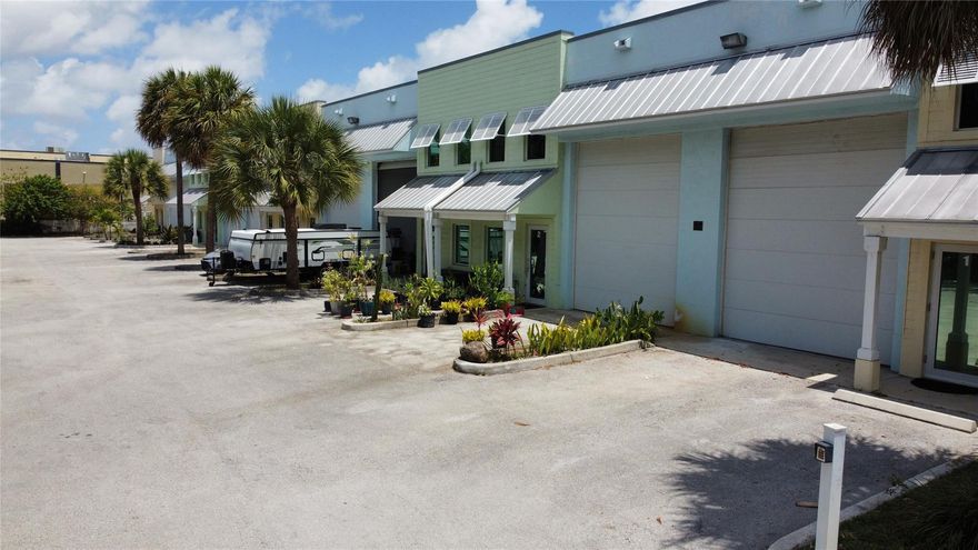 Creative space perfect for studio, flex/office, or warehouse use, with fantastic curb appeal. Built in 2008, this unique 1,500 SF (+/-) space includes a full bathroom, kitchen, and even a car lift. Features a mezzanine, sepreate office space, and fully air-conditioned bay with 20' ceilings and a 14' electric overhead door. Unit comes with 2 reserved parking spaces as well as access to common spaces. Securely gated with code access after hrs. Need space to store your cars, camper or a boat? Or looking for a well positioned headquarters to run your business? This space if perfect for anyone seeking a versatile, upscale space in a prime location.