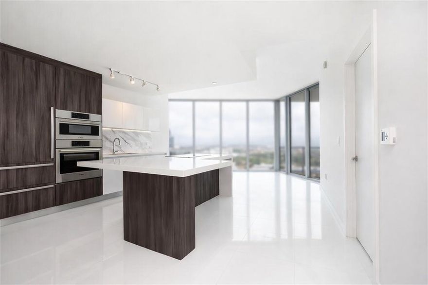 Step into the impressive 1-bed+den, 2-full-bathroom residence at Paramount Miami World Centre. The private foyer and elevator open to a bright space with 10 ft high ceilings and white porcelain tile floors. The unit includes a spacious den or office with an extra bathroom for convenience. The well-equipped kitchen boasts Bosch appliances, white cabinets, and quartz countertops. The master bedroom is a retreat with ample space, large walk-in closets, and an ensuite bathroom featuring double vanity sinks, a soaking tub, and a shower. Paramount Miami World Centre offers hotel-style amenities, including pools, basketball courts, racquetball facilities, and more. This residence blends luxury living, modern design, and a range of amenities. Rent includes Internet, cable, and water!