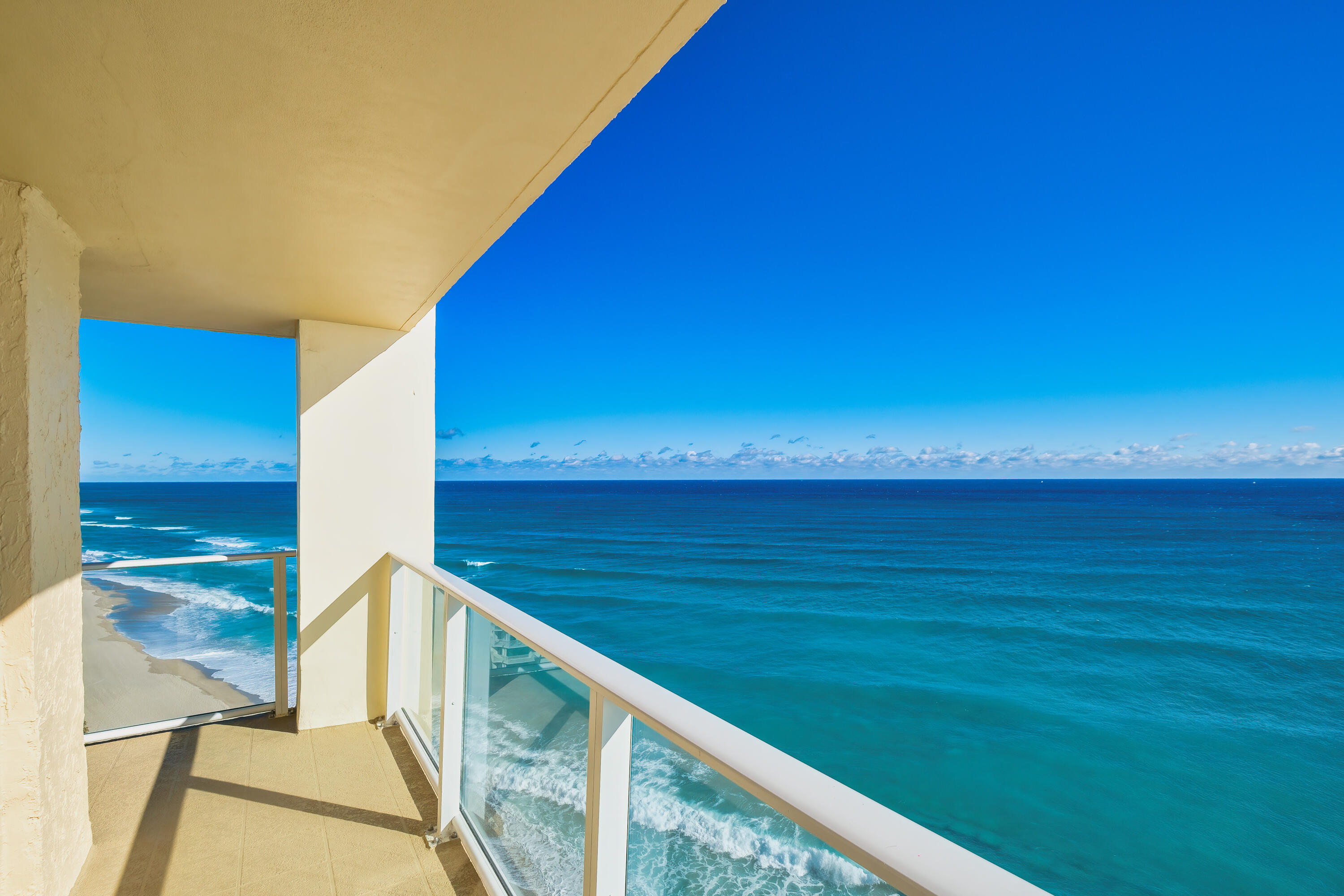 Experience coastal living at its finest in this stunning northeast corner residence with breathtaking, uninterrupted ocean views from every room - including the living room, dining room, kitchen, and both bedrooms. Step into awe as you explore this beautifully renovated 2-bedroom, 2-bath home, designed with a modern and open floor plan. The kitchen boasts custom features and an island that comfortably accommodates at least 4 people. Upgrades abound throughout the residence, with fully renovated bathrooms, tile floors in the bedrooms, tile floors in the main living areas, crown molding, Bosch washer/dryer, and hurricane impact glass. The expansive wraparound glass balcony provides panoramic views of the ocean and intracoastal, and the abundance of windows in this corner unit