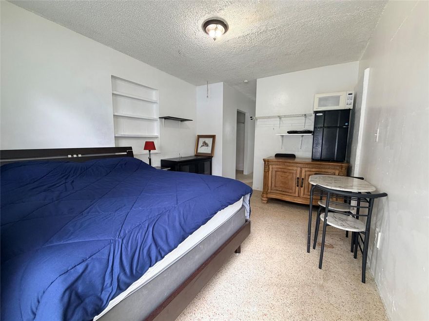 Come check out this cozy and bright studio - Move-in Ready!  This charming studio offers a clean, comfortable living space with everything you need in one convenient layout.  Enjoy a welcoming open room featuring a full-sized bed, build in shelving and a compact dining nook, perfect for work & meals.  The unit includes a refrigerator, microwave and stove top.  Large windows allow for a lot of light in the living area and the immaculately updated bathroom.  The bathroom has been updated with modern tile, a full bathtub/shower combo and a bright aesthetic.  Rental welcomes all term lengths $1000 monthly rent | $600 bi-weekly | $350 weekly | with $100 added for monthly utilities.  Come check it out an apply asap, won't last!