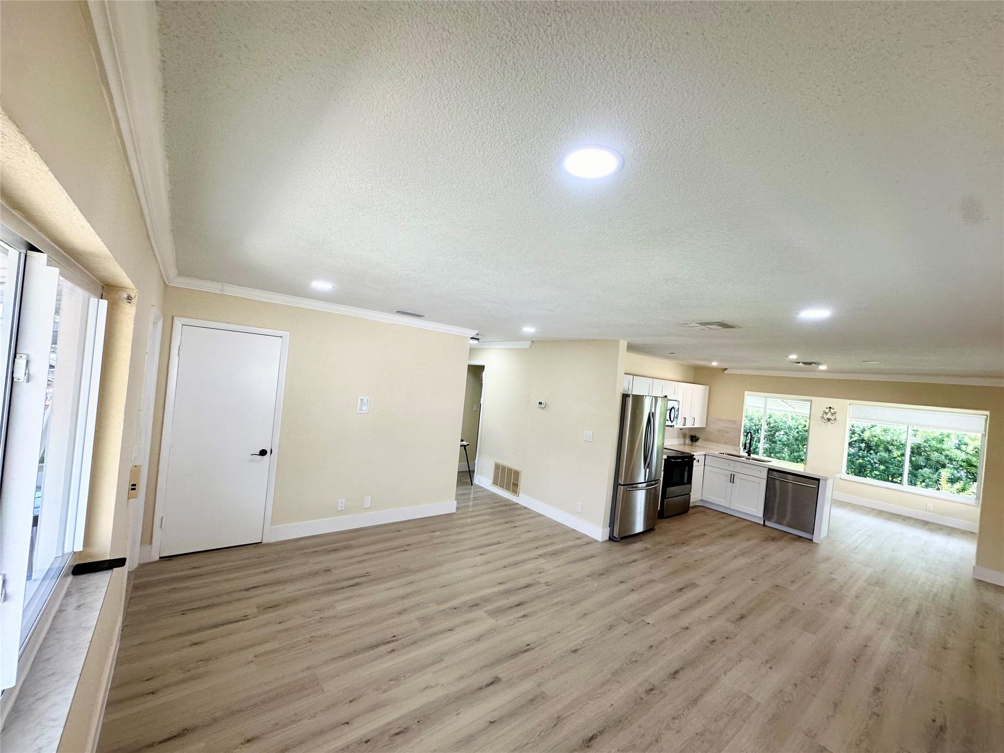 Priced below appraisal value! Very quiet street in the Mainlands of Tamarac. 55+ community. One occupant must be 55 and over. Home has a newer roof, newer attic insulation and new AC ducts. One full bath and the other bathroom does not have a shower.  The kitchen is GORGEOUS - soft close cabinets and drawers, quartz countertops, recessed LED lighting, and a modern subway tile backsplash. The entire home has luxury vinyl plank flooring which is 100% waterproof. – the flooring is beautiful! Home has a transferable Termite warranty! New gutters, updated electric panel, and IMPACT windows. Stacked washer and dryer unit is located on the outside covered patio area.  Monthly HOA fee is $100. No Children under 18. Yes, the HOA does require a 730 Credit Score(TransUnion). See MLS attachments.