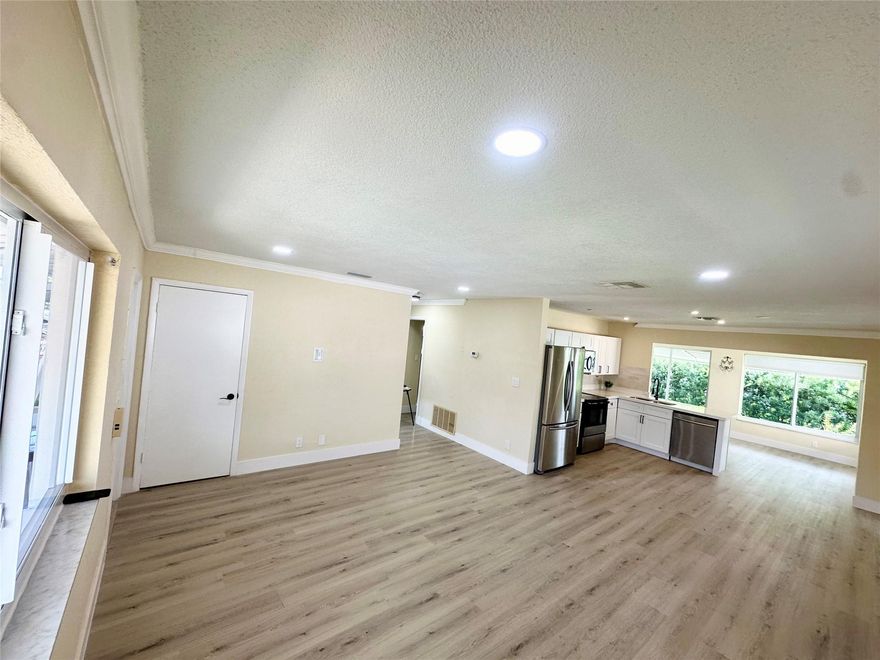 Priced below appraisal value! Very quiet street in the Mainlands of Tamarac. 55+ community. One occupant must be 55 and over. Home has a newer roof, newer attic insulation and new AC ducts. One full bath and the other bathroom does not have a shower.  The kitchen is GORGEOUS - soft close cabinets and drawers, quartz countertops, recessed LED lighting, and a modern subway tile backsplash. The entire home has luxury vinyl plank flooring which is 100% waterproof. – the flooring is beautiful! Home has a transferable Termite warranty! New gutters, updated electric panel, and IMPACT windows. Stacked washer and dryer unit is located on the outside covered patio area.  Monthly HOA fee is $100. No Children under 18. Yes, the HOA does require a 730 Credit Score(TransUnion). See MLS attachments.