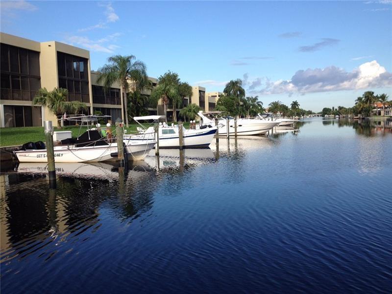 ENJOY LIVING IN THIS RESORT STYLE, SMALL BOUTIQUE WATERFRONT COMMUNITY WHERE EVERY OWNER HAS HIS OWN PRIVIATE DOCK INCLUDED. IN ADDITION TO FREE DOCKAGE, THIS IS A TWO- PET FRIENDLY COMMUNITY WHERE 2 CARS ARE ALSO PERMITTED WITH ONE ASSIGNED AND COIVERED. THIS TOWNHOUSE FLOORPLAN IS 1500 SQ FT & LUXURIOUSLY UPDATED WITH 4 SKYLIGHTS, 2 BALCONIES, AND YOUR BOAT DOCKED RIGHT OFF YOUR BALCONY !!! COMPLEX AMENITIES INCLUDE TWO LIGHTED TENNIS COURTS, PICKELBALL, HOT TUB, HEATED POOL, CLUB HOUSE WITH FITNESS, SAUNA, KITCHEN, WI-FI, ICE MACHINE, CAMERA SECURITY AND A GENERATOR FOR OUR HURRICANE SEASONS. ONLY CONDO IN WATERFRONT COMMUNITY OF GARDEN ISLES. ALL FOUR EXPOSURES AVAIABLE. FRIENDLY PEOPLE, HOLIDAY & SPECIAL OCCASION PARTIES, PRIDE OF OWNERSHIP. BOATER OR NOT, YOU WILL LOVE IT HERE!