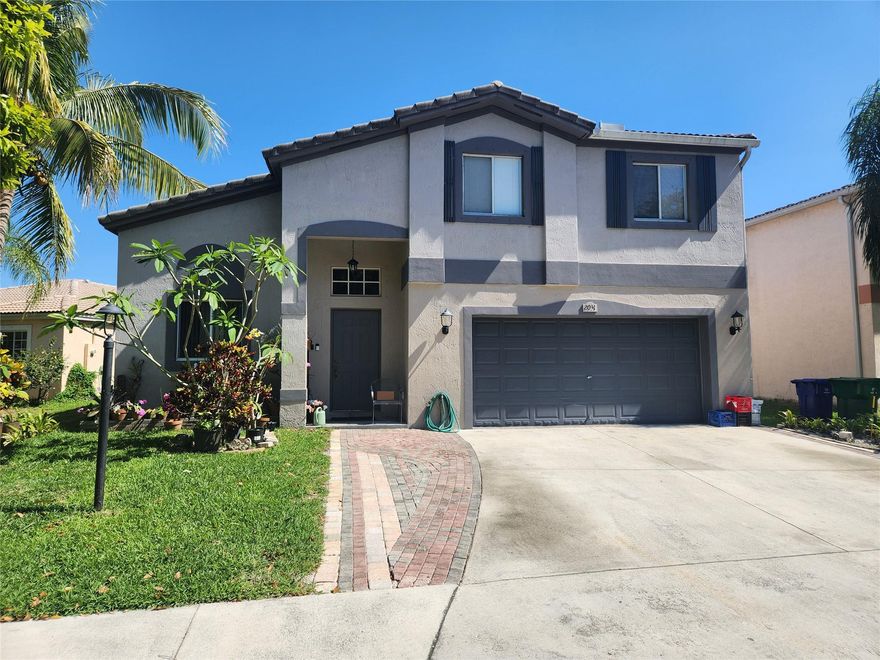STUNNING HOME FEATURES UPGRADED KITCHEN WITH STAINLESS STEELE APPLIANCES, UPGRADED BATHROOMS, HIGH CELING IN LIVING ROOM & FAMILY OOM, CROWN MOLDING, LAMINATED FLOORS, DOUBLE SINK IN MASTER BATHROOM, ADDITIONAL STORAGE CLOSET & MUCH MORE....IDEAL FOR ENTERTAINING, RELAX & ENJOY LARGE BACK YARD WATER VIEW. LOTS OF FRUIT TREES.  CLOSE TO SHOPS, RESTAURANTS, CHURCHES & FT. LAUDERDALE & MIAMI AIRPORT.